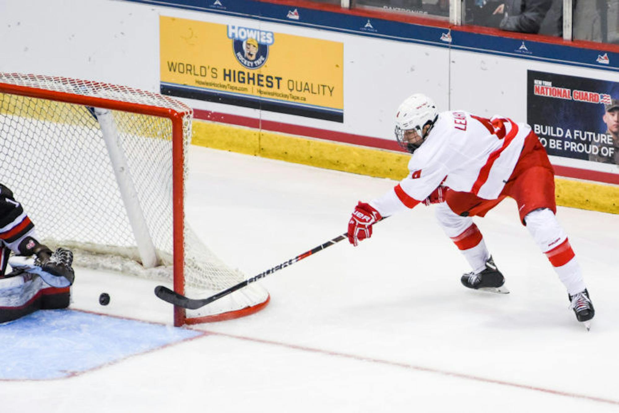 Freshman defenseman Joe Leahy scores his first collegiate goal during the ECAC semifinal game against Brown at Lake Placid on Friday. The Red cruised to a 6-0 victory, effectively securing a place in the NCAA tournament. (Boris Tsang / Sun Photography Editor)