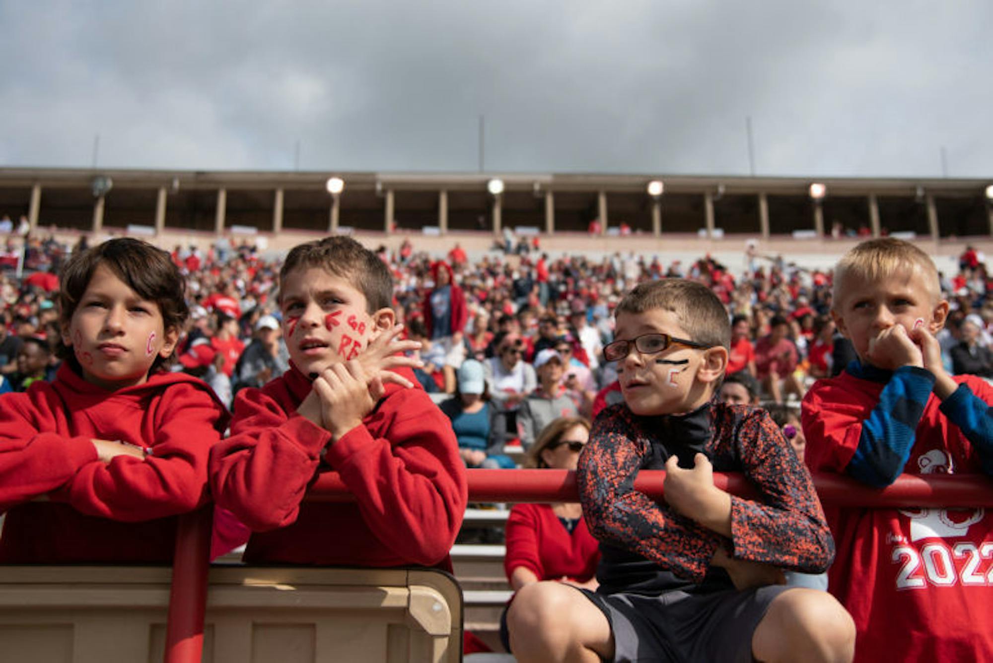 A group of boys awaits the start of the Homecoming game at Schoellkopf Field. (Michael Wenye Li / Sun Photography Editor)
