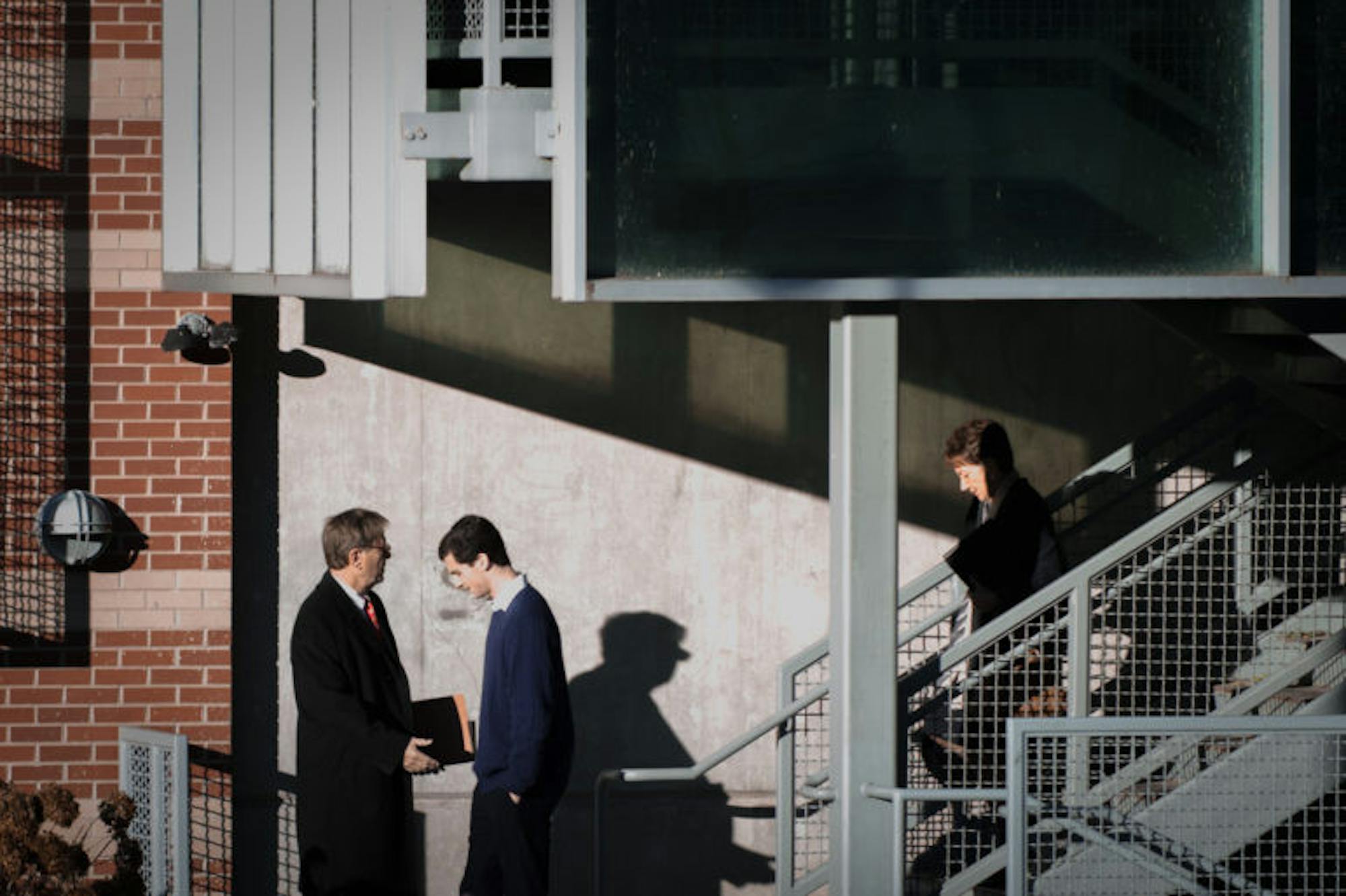 Greenwood, in blue, enters Ithaca City Court on Wednesday, Nov. 29, 2017.
