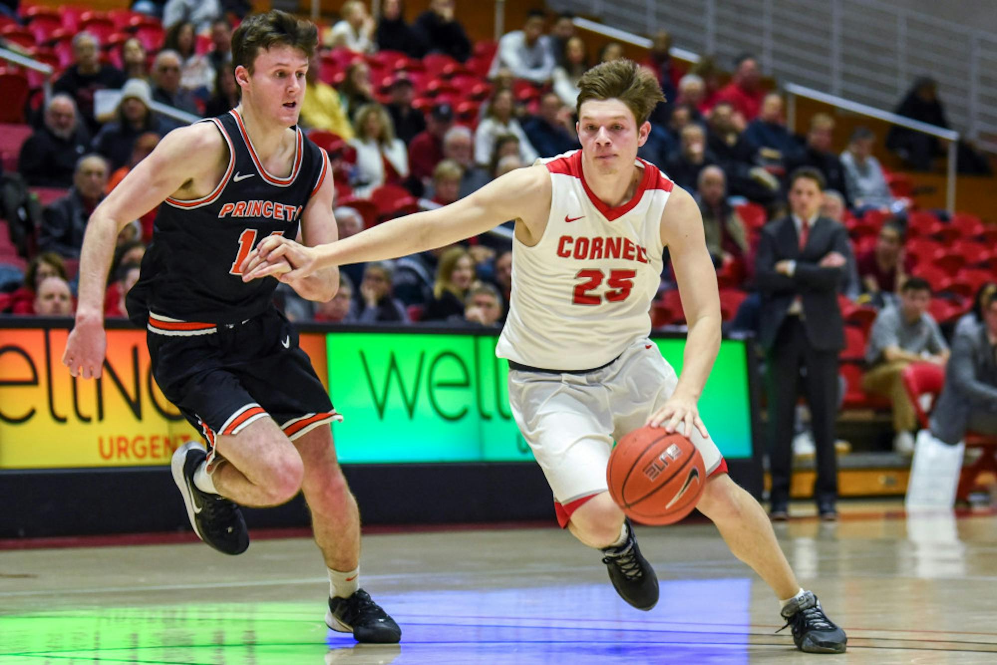 Sophomore guard Dean Noll dribbles the ball at the men's basketball game against Princeton on Saturday. The Red won 73-62 against Princeton at Newman Arena. (Boris Tsang/Sun Photography Editor)