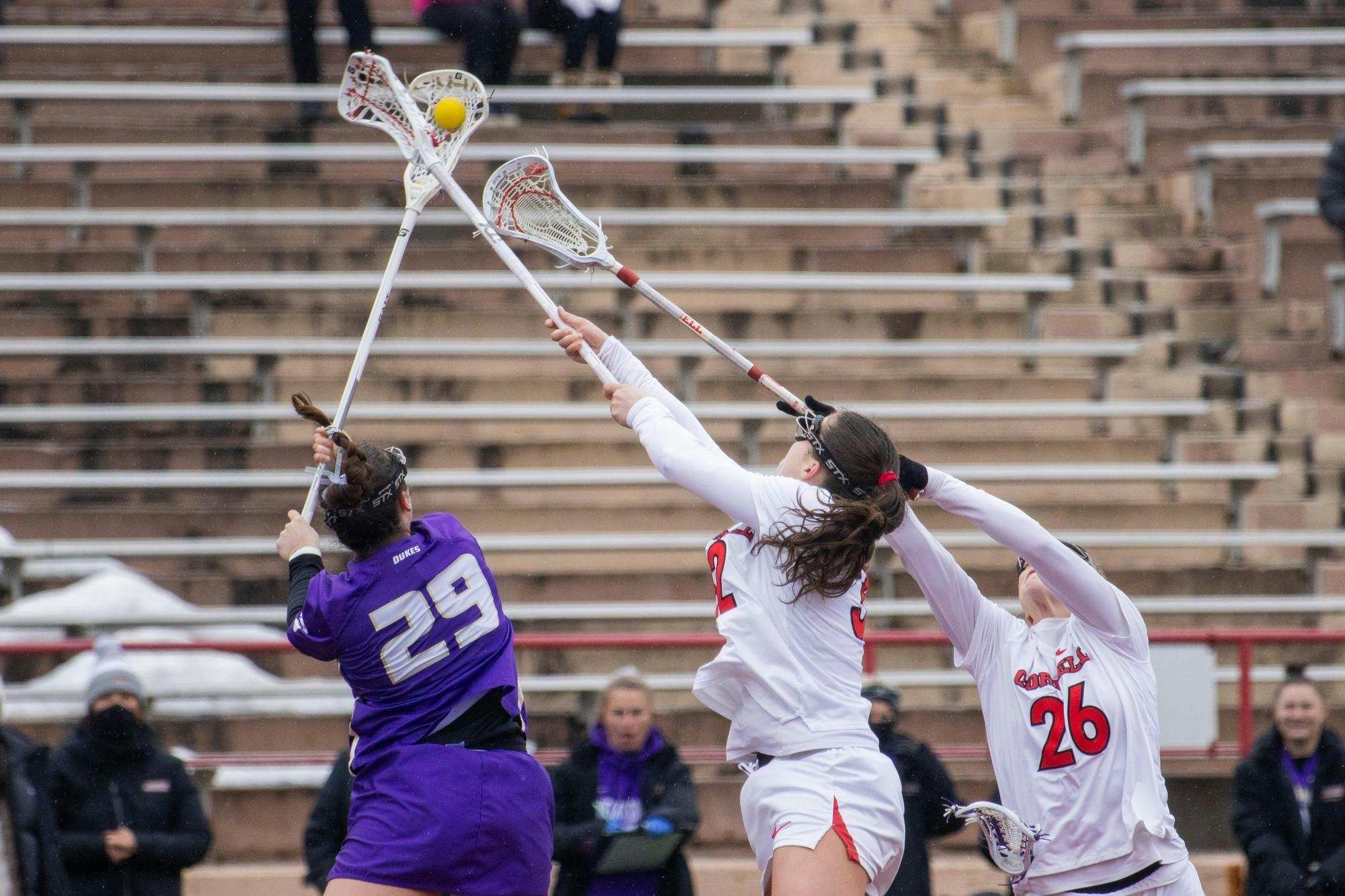 Attacker and Captain Ellie Bergin '27 fights for possesion during face-off at the women's lacrosse game against James Madison University at Schoellkopf Field on Feb. 22, 2026. (Dante de la Peña/ Sun Staff Photographer)