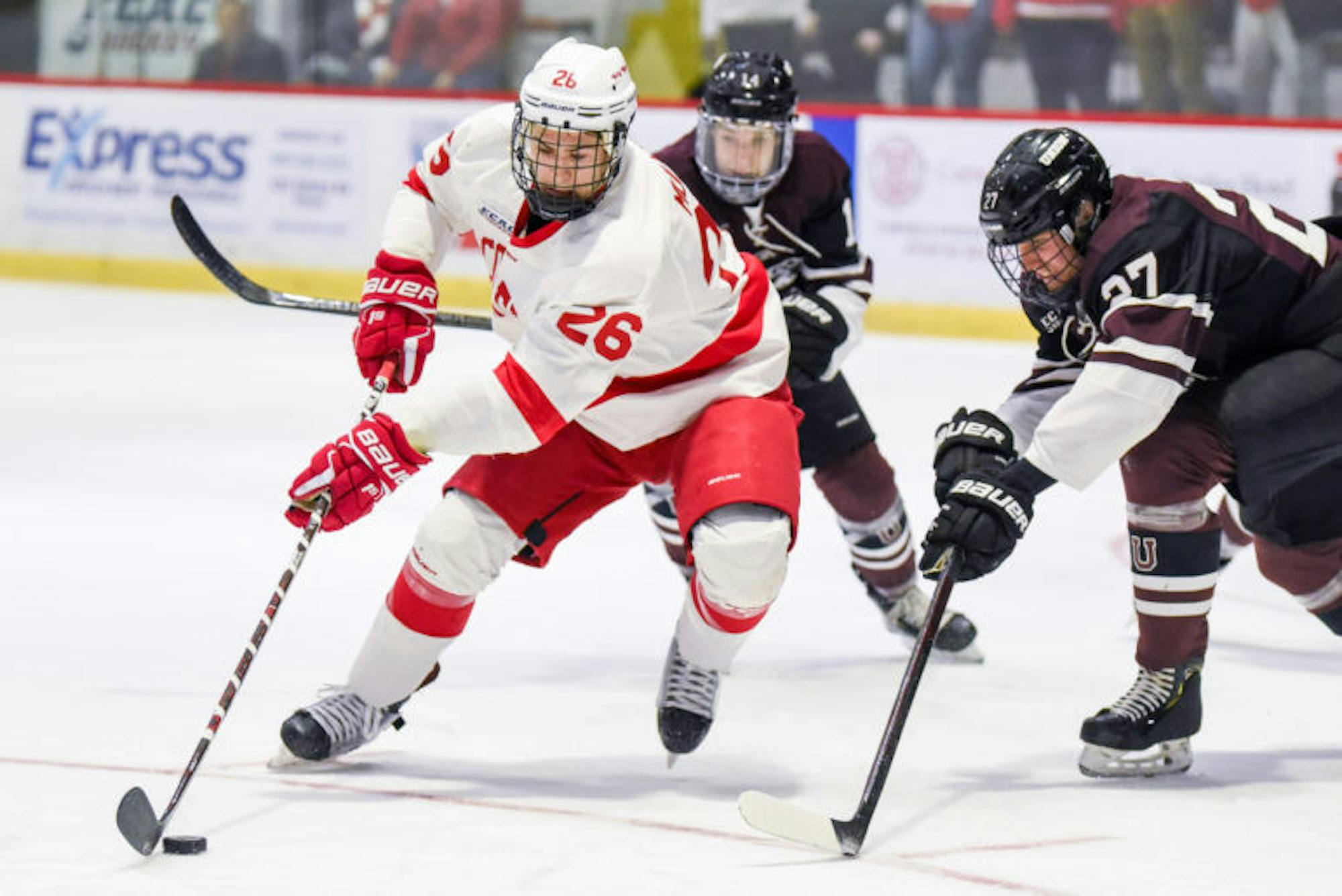 Sophomore forward Tristan Mullin advances the puck during Saturday's game against Union. The Red finished its final regular season home game with a 3-1 victory. (Boris Tsang / Sun Assistant Photography Editor)