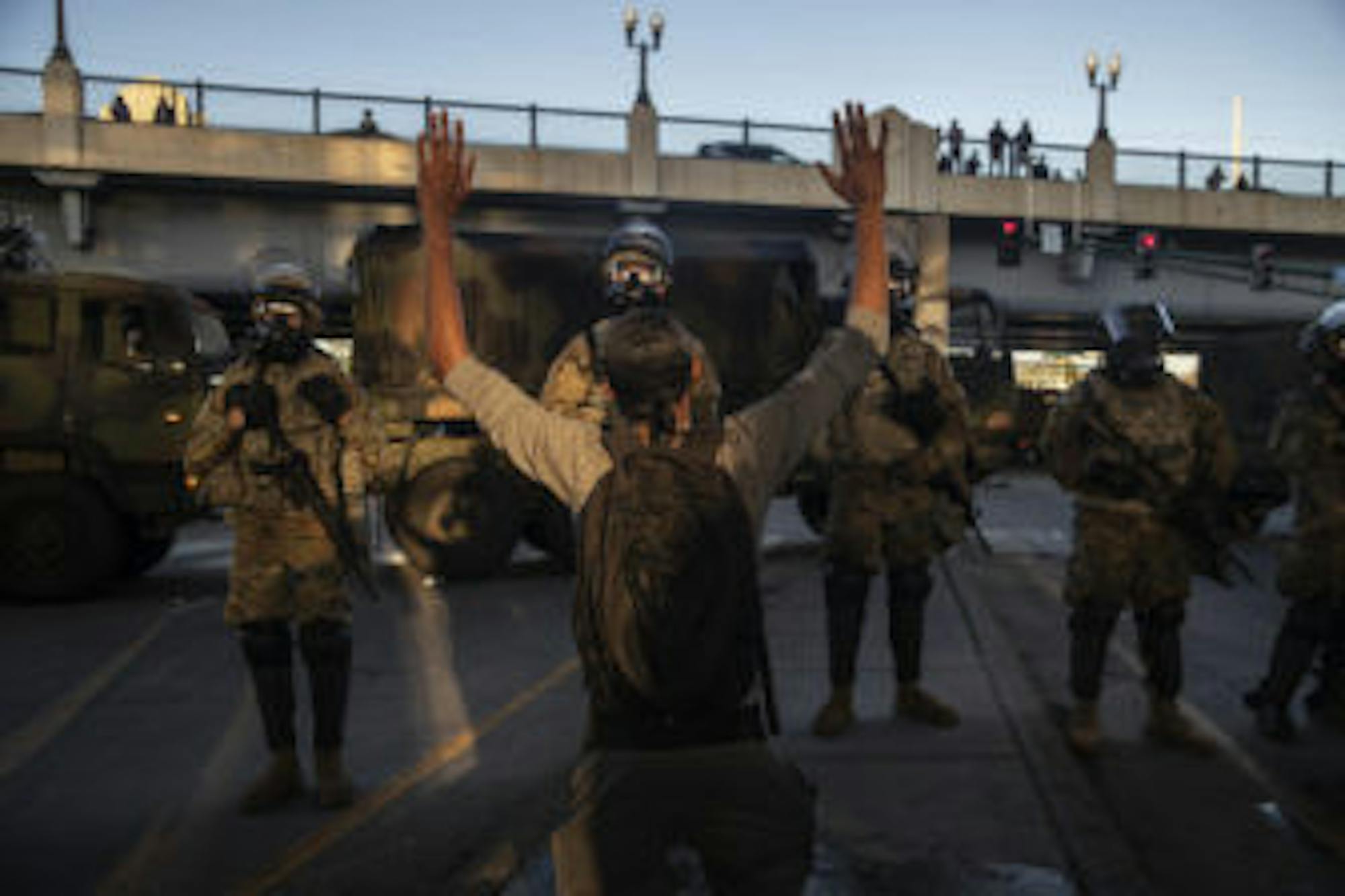 A demonstrator raises their hands as they stand off with members of the Minnesota National Guard, during a protest against the death of George Floyd and police brutality, in Minneapolis on May 29.