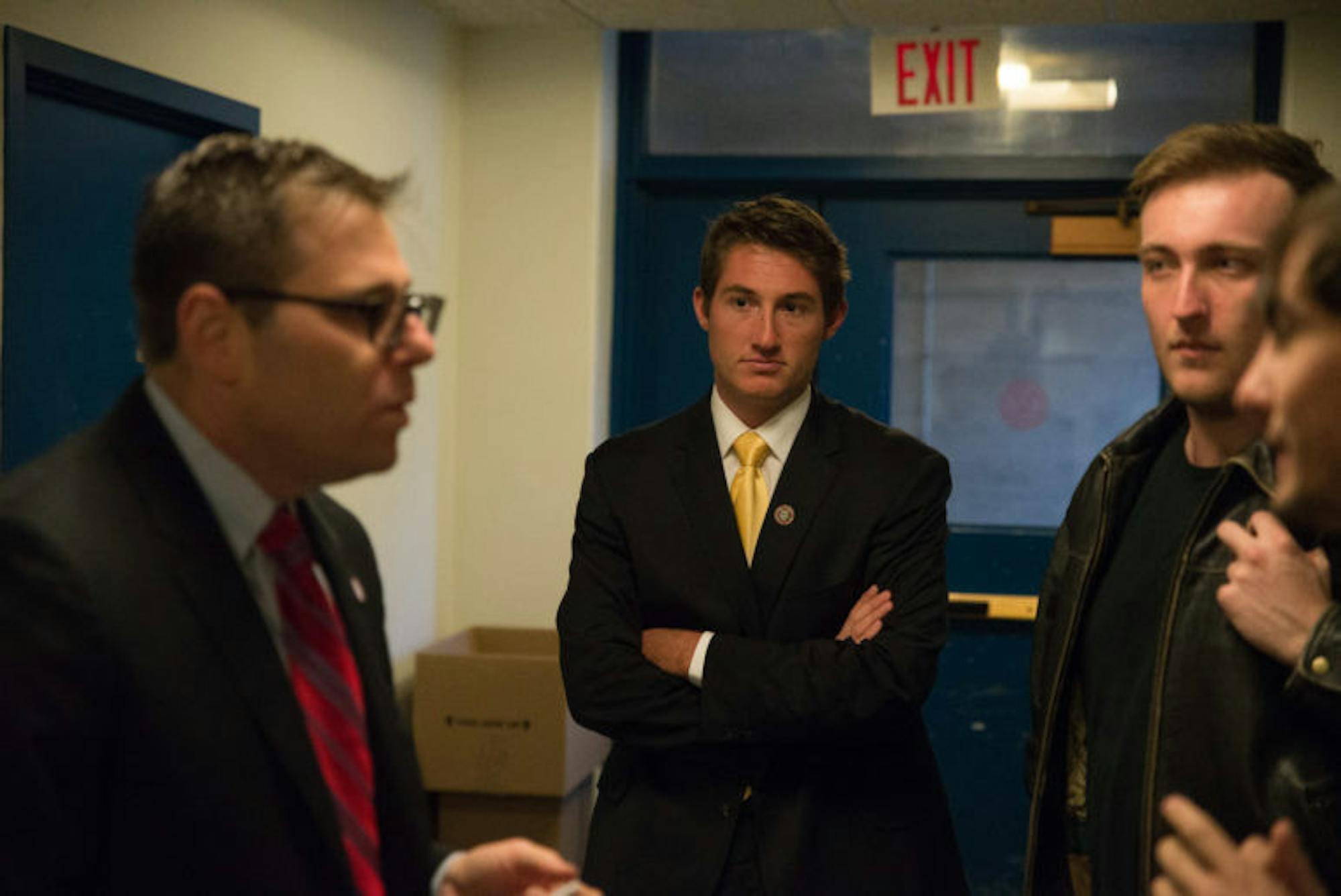 Mitch McBride '17 stands with his lawyer, Alan Sash, left, in Day Hall, where the University Hearing Board cleared him of both charges on Wednesday.