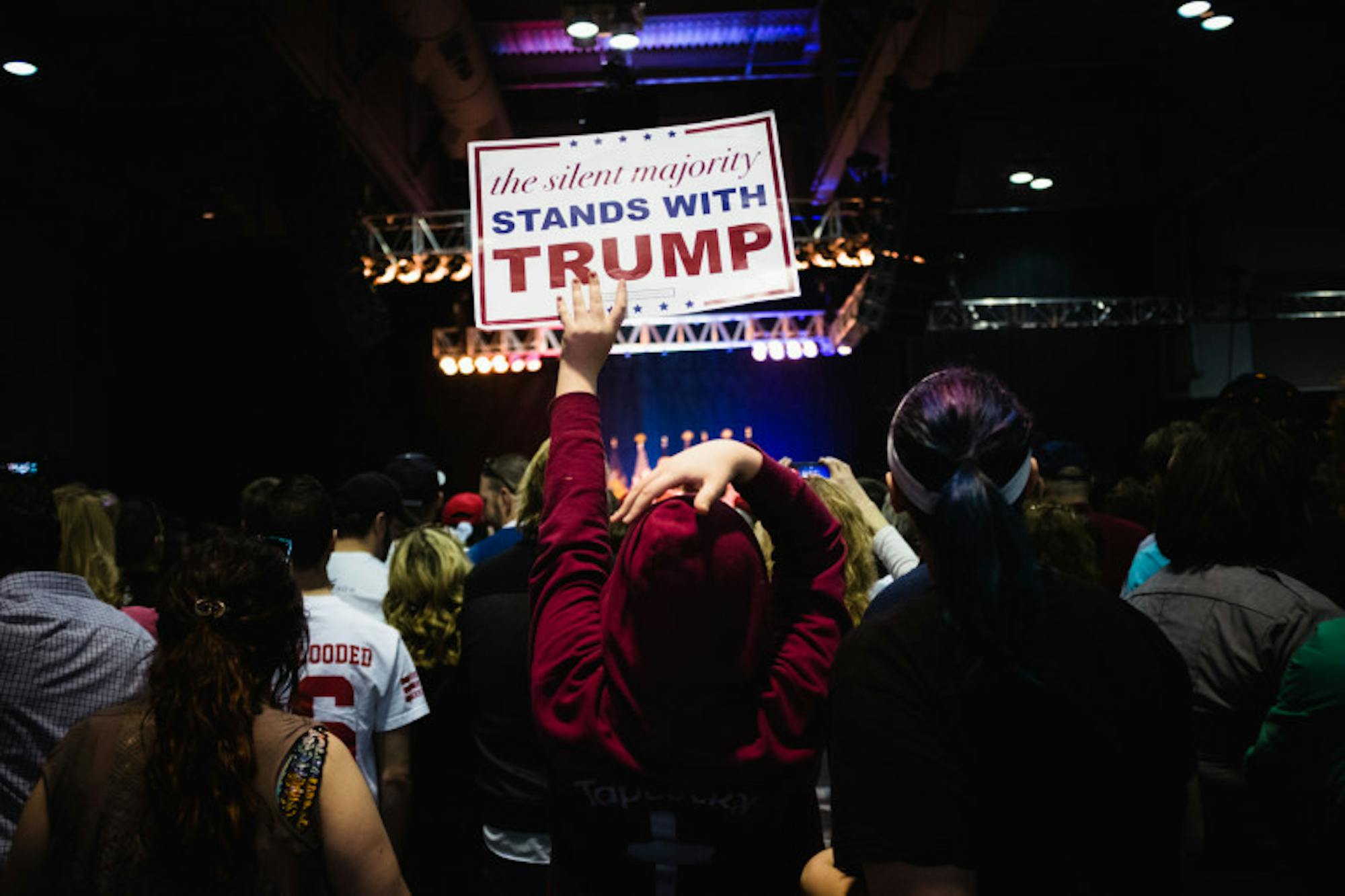 Supporters hoist signs at a Donald Trump rally in Syracuse.