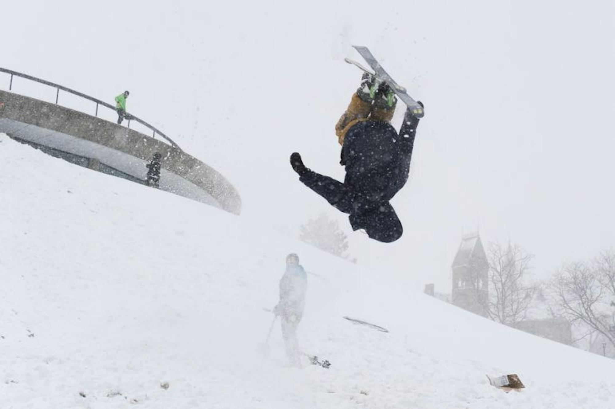 Wyatt Buchalter '18 completes a flip as he skis down Libe Slope during Winter Storm Stella on Tuesday.