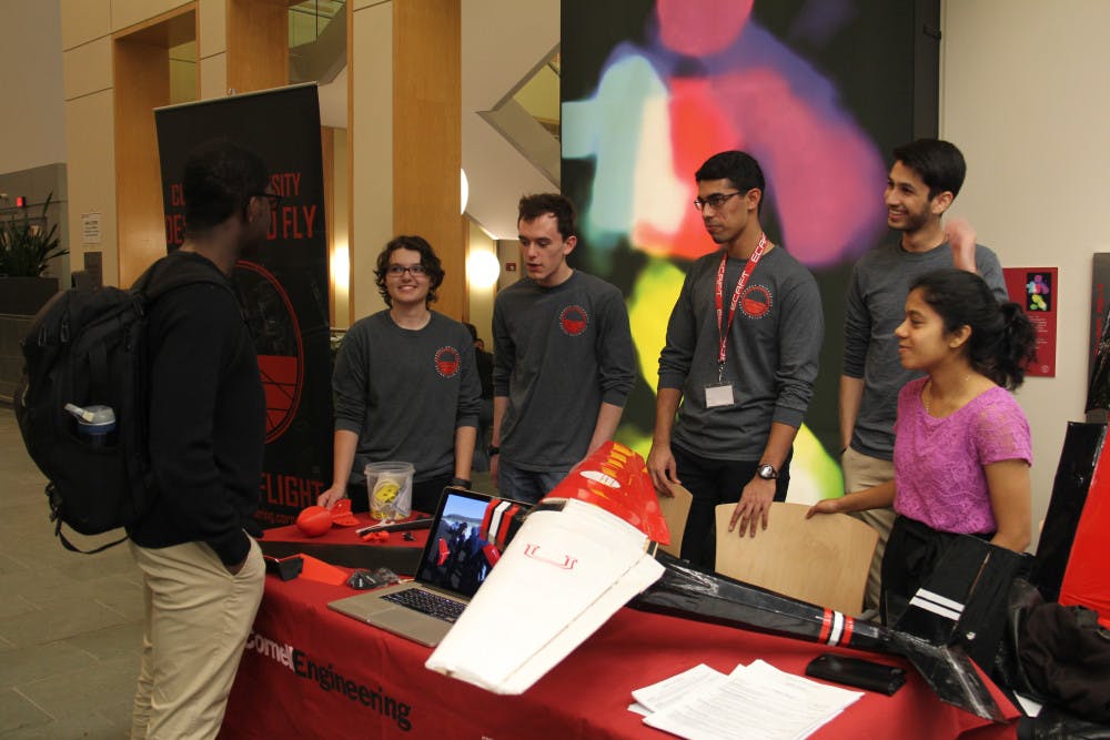 Members-of-Cornell-Design-Build-Fly-talk-to-visitors.