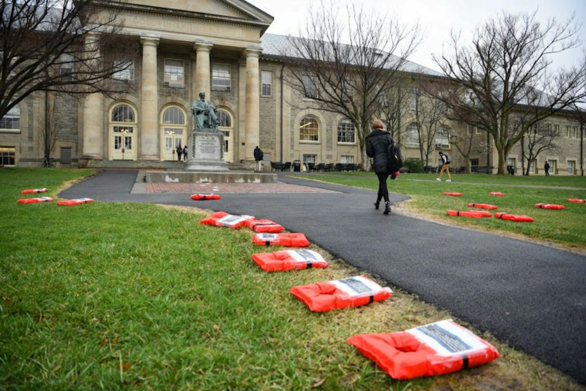 Cornell Welcomes Refugees (CWR) partnered with 12 other student groups to organize the “Week of Action for Refugees”. Life jackets with testimonials of refugees were placed on the Arts Quad as part of the initiative. (Boris Tsang / Sun Photography Editor)