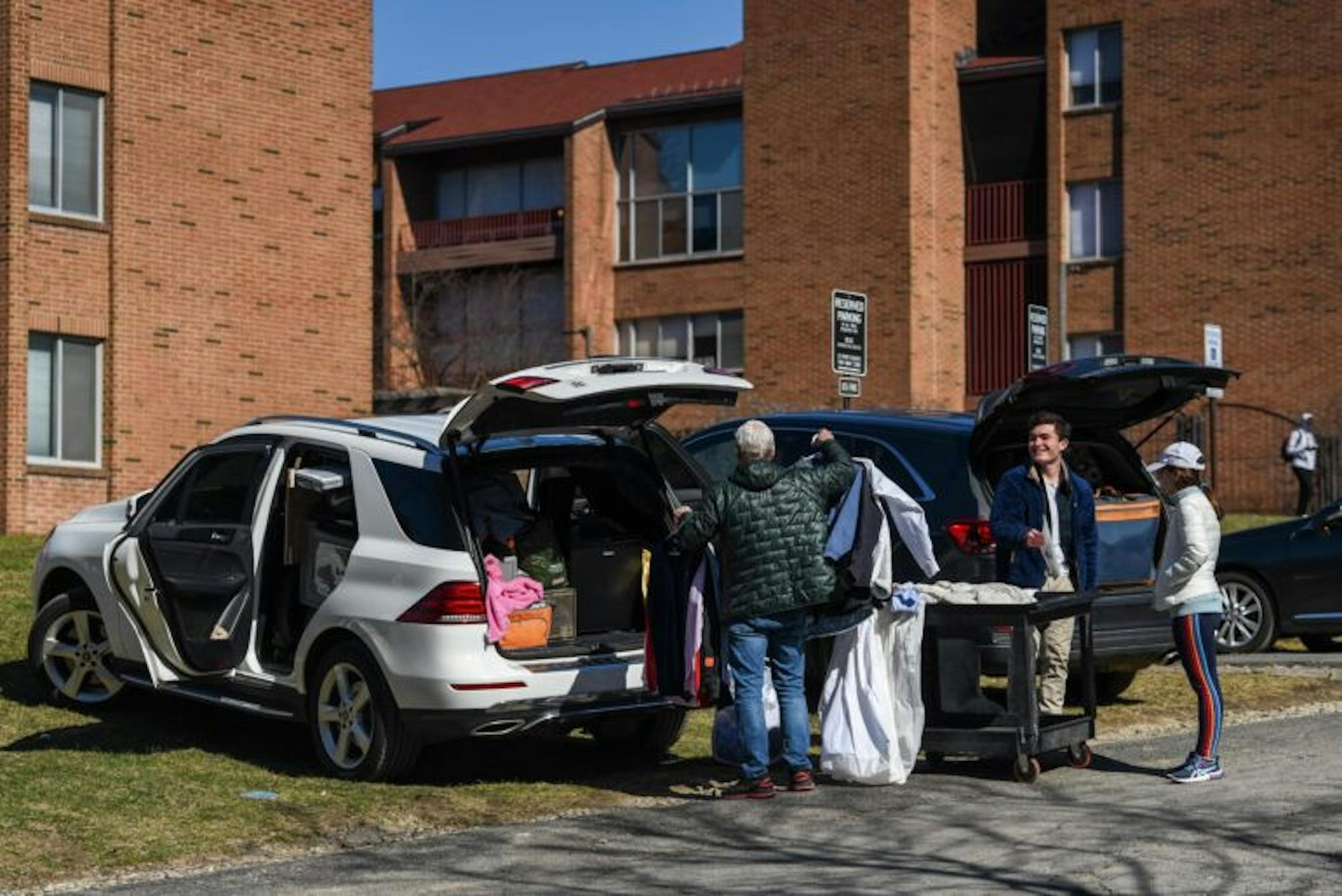 Students load their cars at the parking lot behind Ujamaa Residential College on Saturday. North Campus filled with cars and parents following President Pollack's announcement that classes will be suspended until April 6 because of COVID-19. (Boris Tsang / Sun Photography Editor)