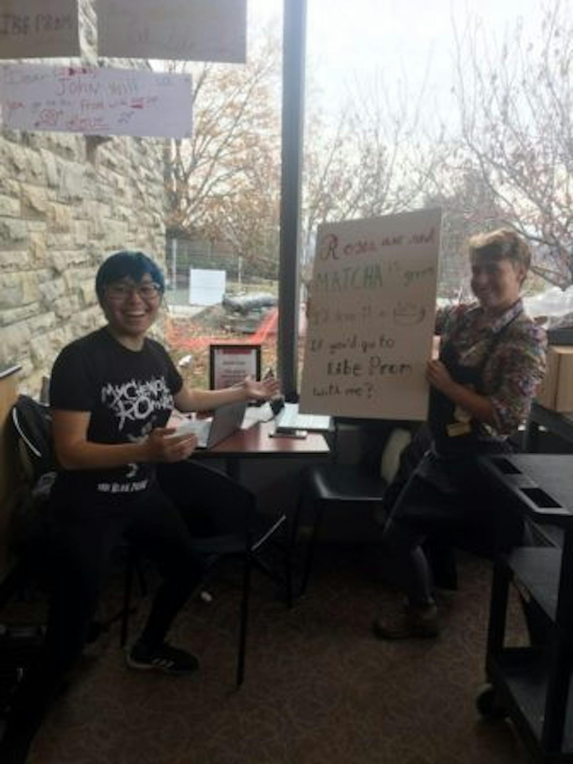 Students gather with a promposal poster.