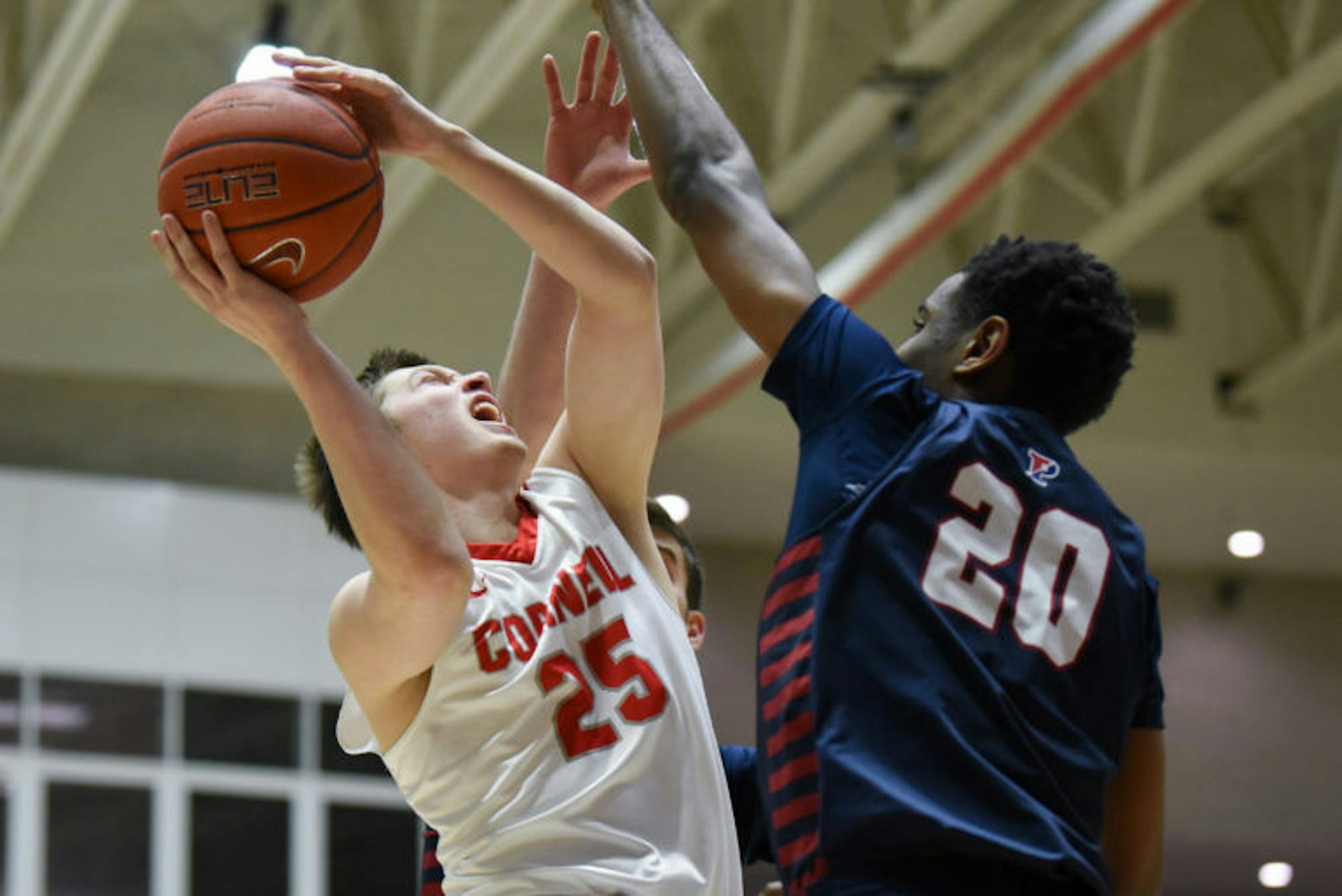 Freshman guard Dean Noll goes up for a layup during the men's basketball team's 80-71 victory over Penn. (Boris Tsang / Sun Assistant Photography Editor)