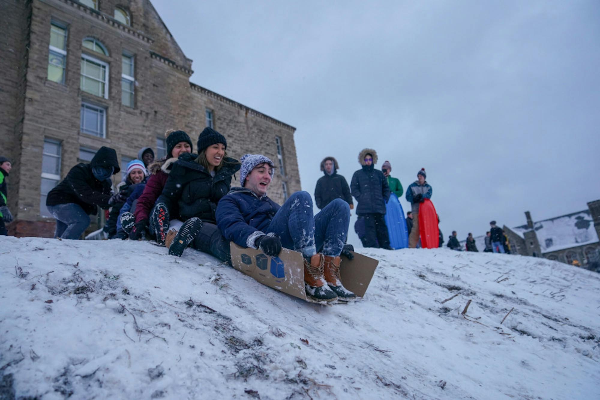 On Friday students flocked to Libe Slope to go sledding on the first snow day of the semester, using everything from toboggans to cardboard boxes. (Ben Parker/Sun Assistant Photography Editor)