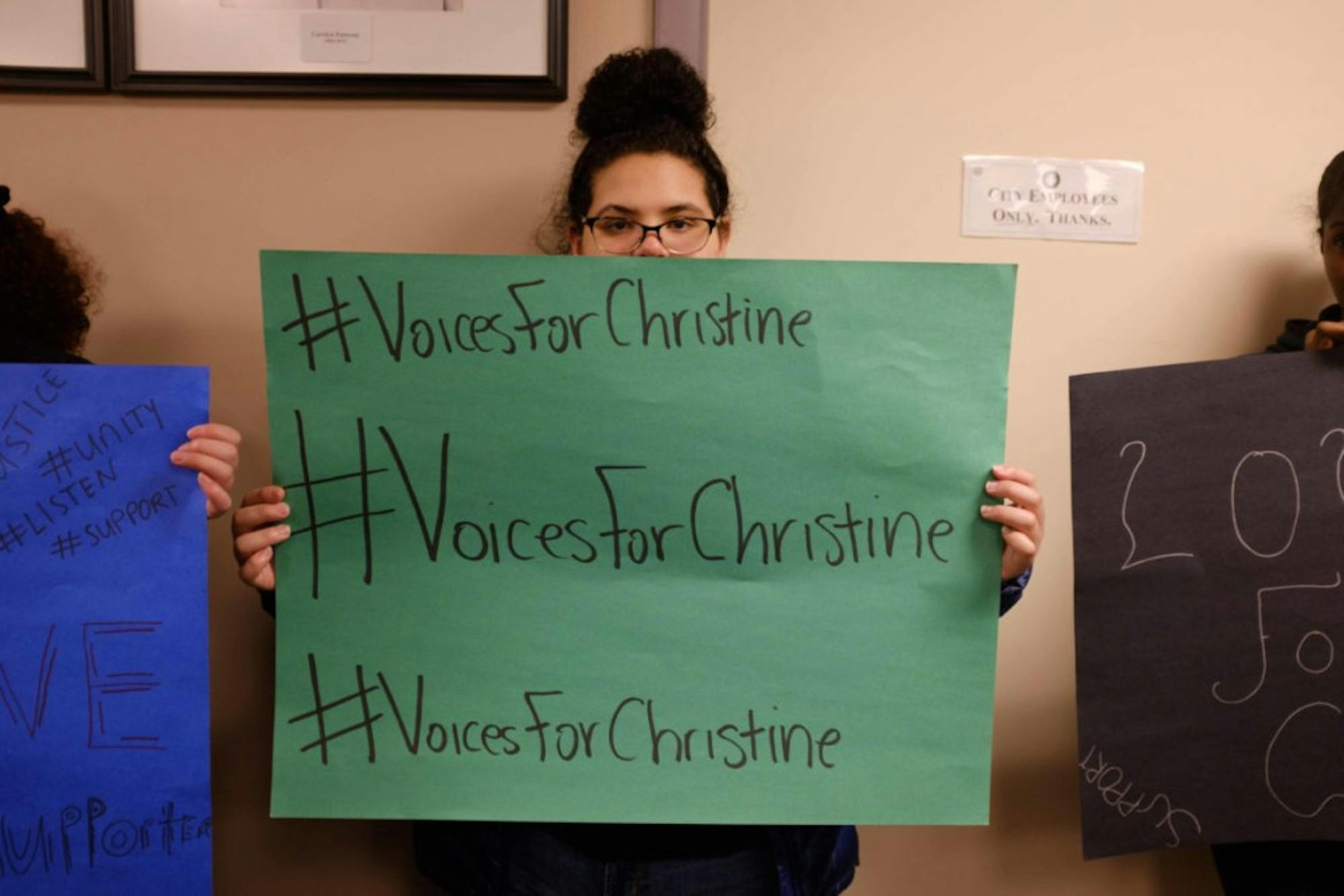A student protestor holds a sign in support of Christine Barksdale on Wednesday. (Michael Suguitan/Sun Staff Photographer)