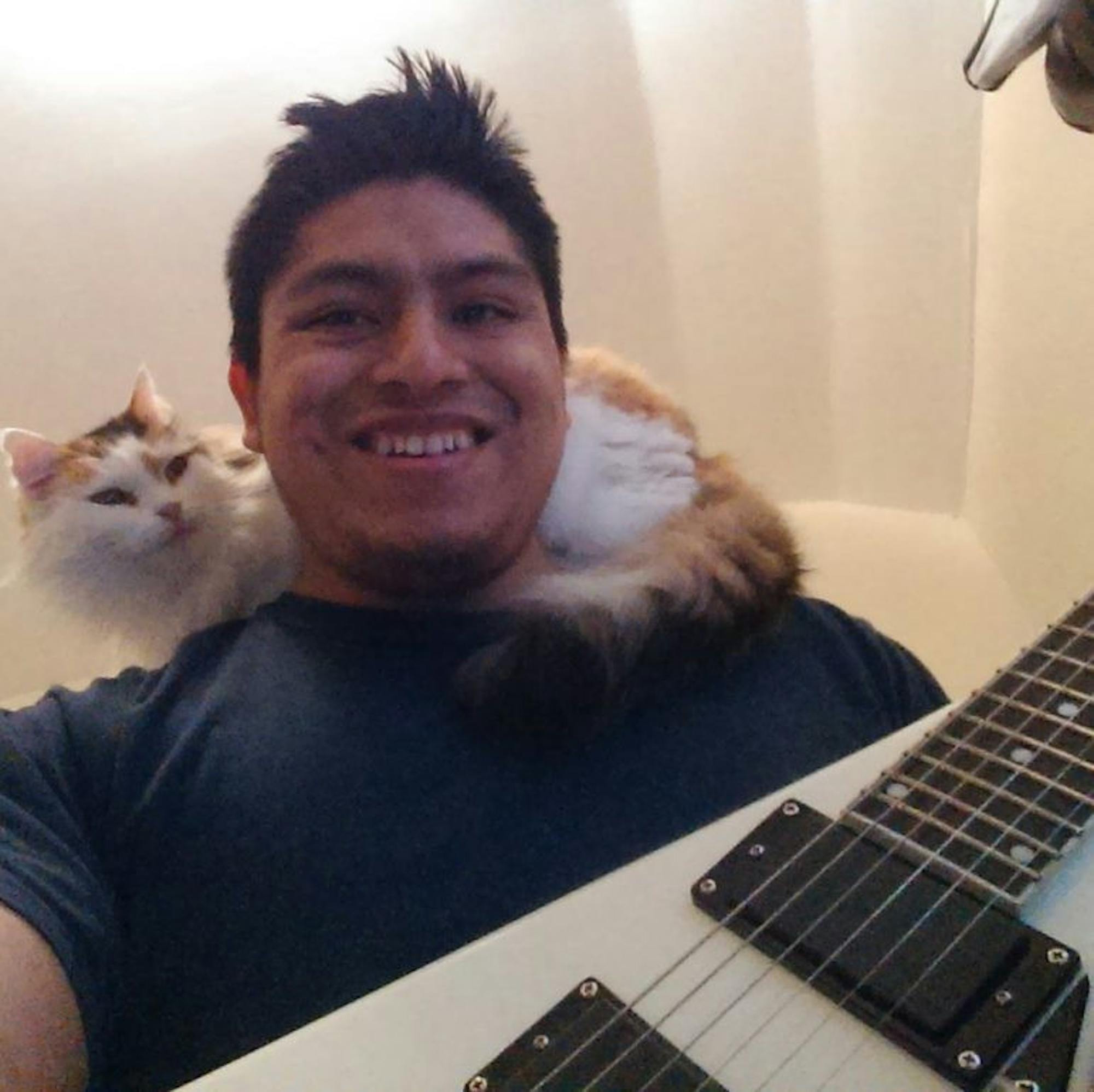 José Guzman-Lopez, 32, pictured here with his cat and guitar.