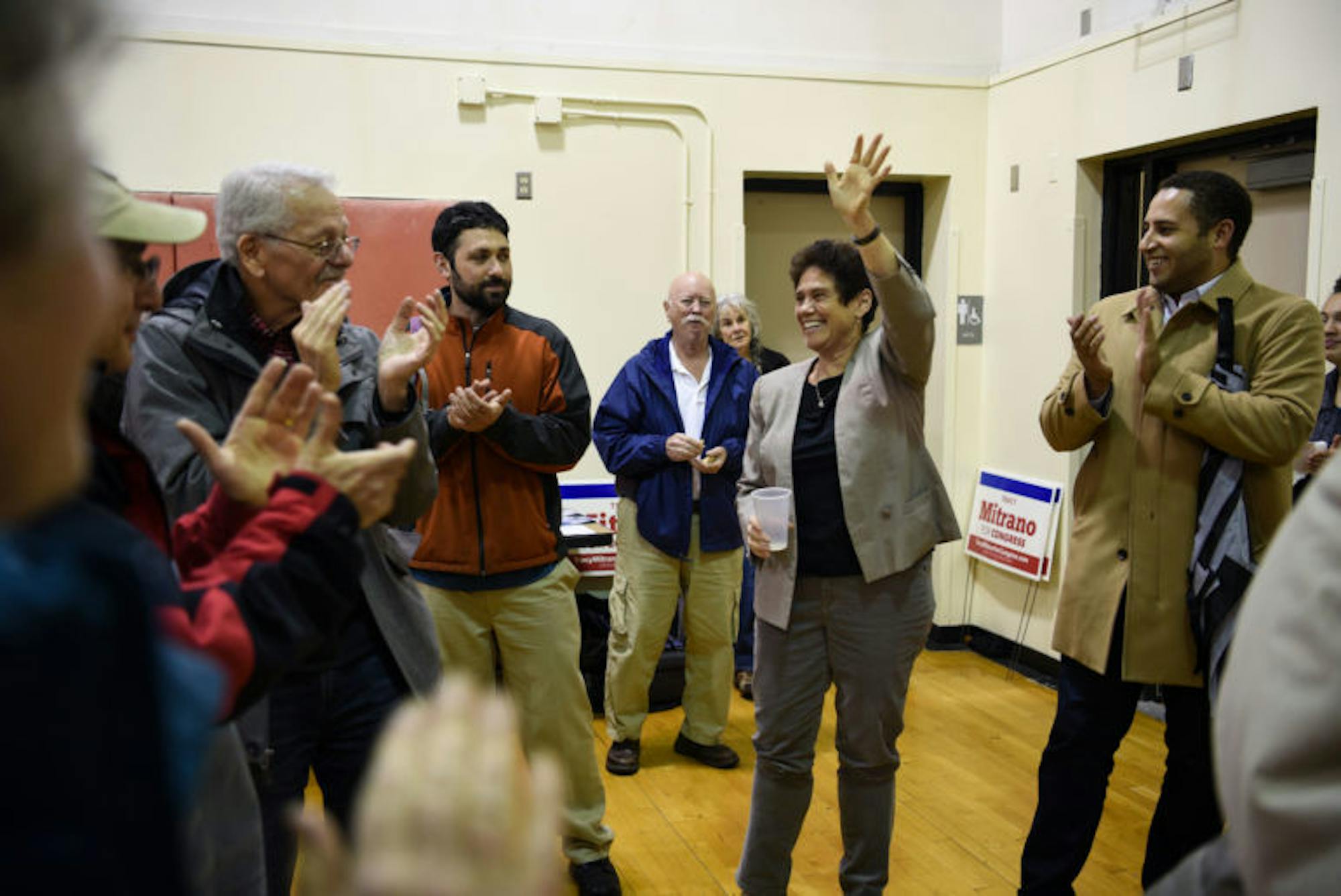 Supporters, including Ithaca Mayor Svante Myrick ’09, cheer on Democratic congressional candidate Tracy Mitrano J.D. ’95 at a rally on Monday. Although incumbent Rep. Tom Reed (R-N.Y.) stills leads in polls, the margin has decreased in recent weeks, giving Mitrano a better chance at winning than the two previous Democratic challengers. (Boris Tsang / Sun Assistant Photography Editor)