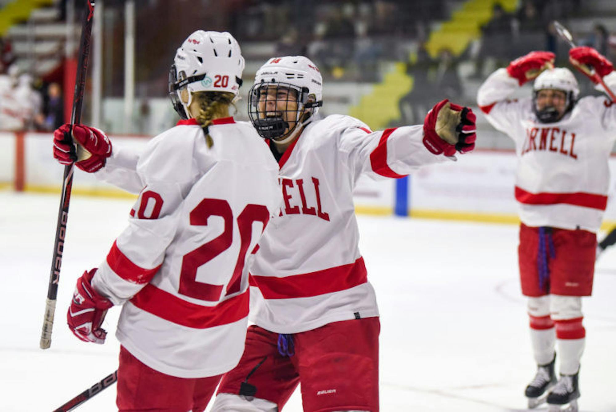 The women's hockey team celebrates after junior forward and co-captain Kirstin O’Neill scores a goal to put the Red up 5-0 over RPI. (Boris Tsang / Sun Assistant Photography Editor)