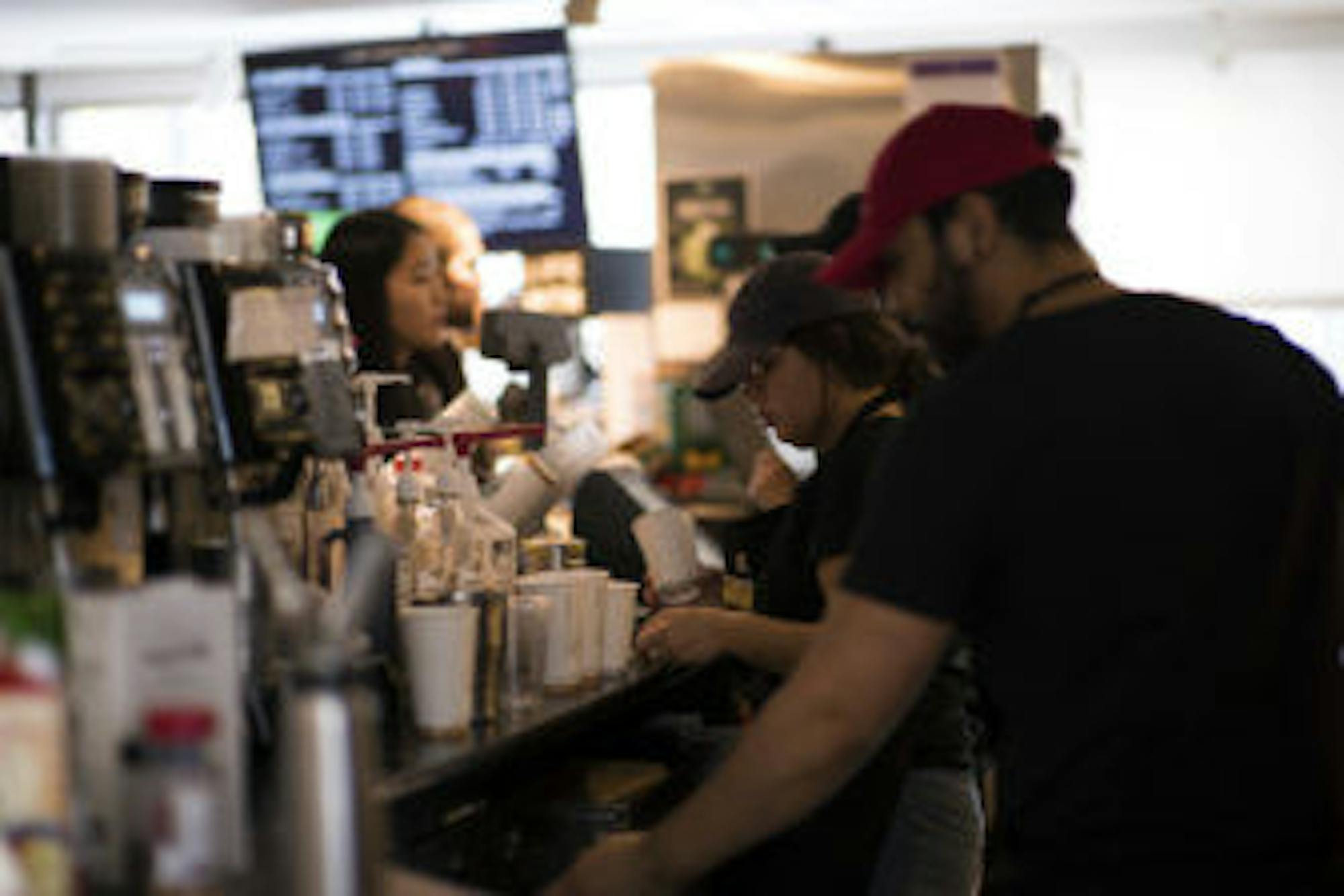 Baristas work in Libe Cafe serving customers.