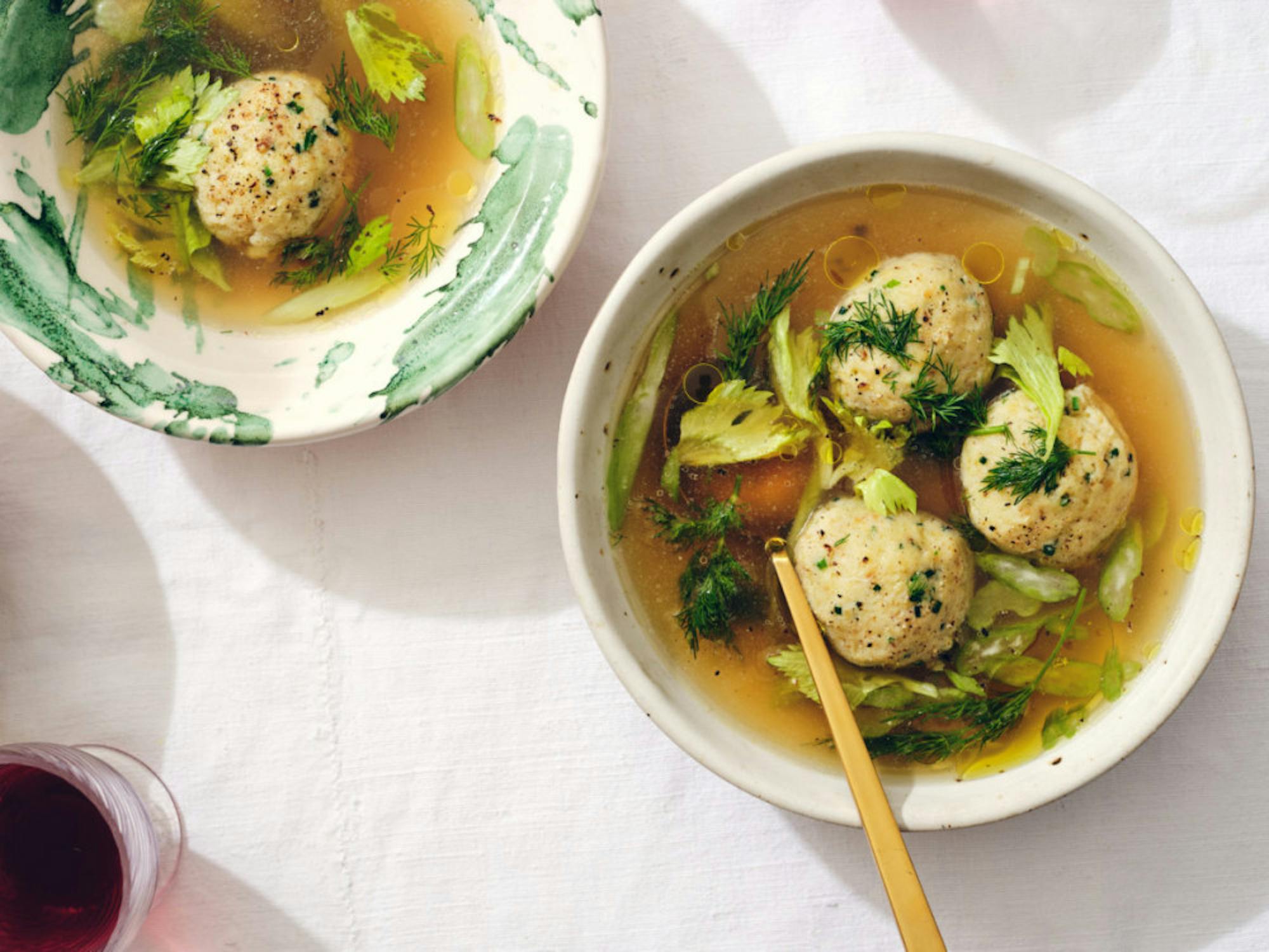 Matzo ball soup with celery and dill, in New York, Feb. 24, 2020. Celebrating Passover, whether it’s alone, virtually or with those in your home, feels more essential than ever — these adaptable recipes can help. Prop Stylist: Kalen Kaminski. ( Michael Graydon & amp; Nikole Herriott / The New York Times)