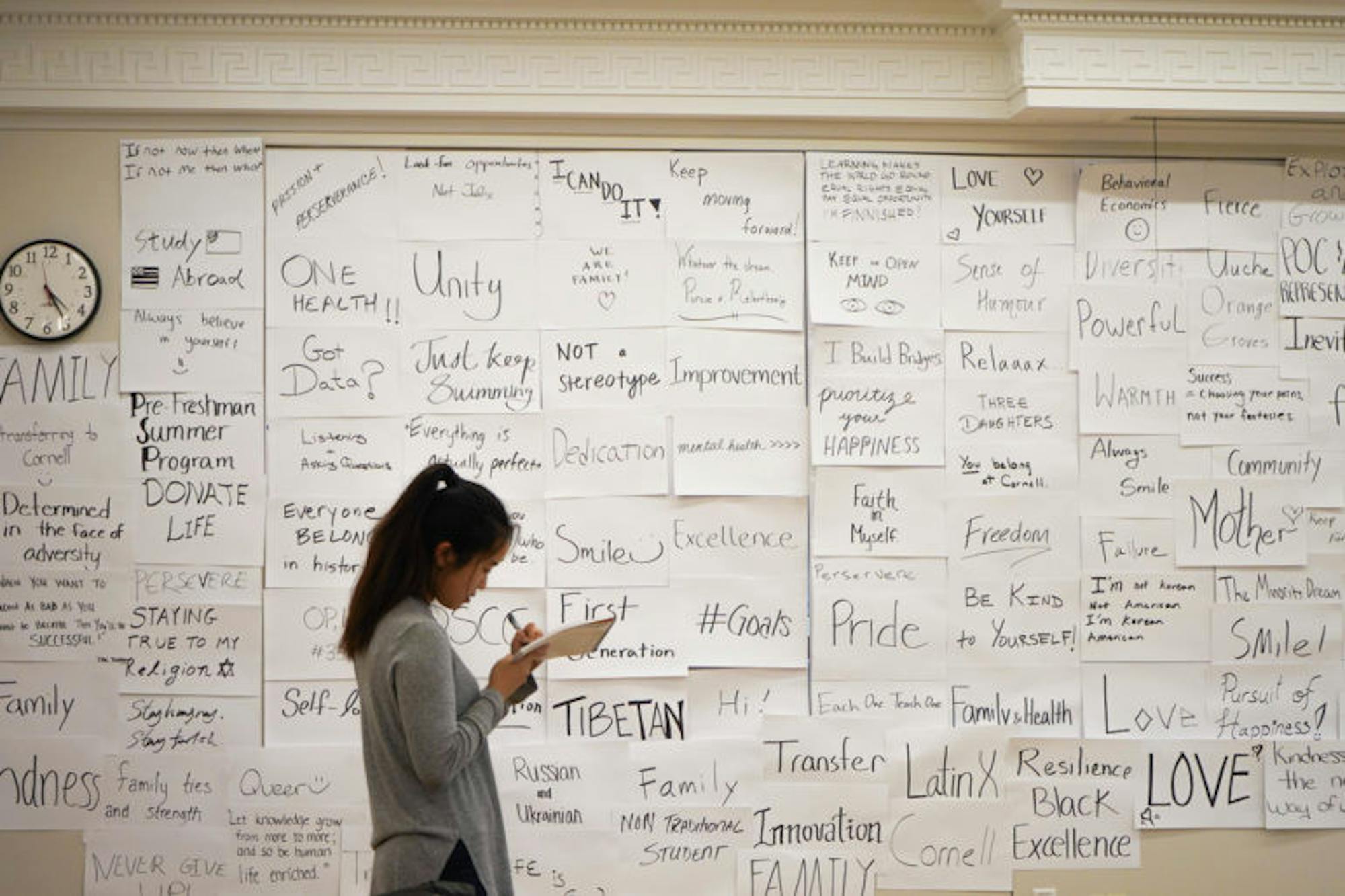 The Charles H. Dyson School of Applied Economics and Management hosted a reception on Tuesday showcasing the results of the “My Story, Our Story” picture campaign. (Jing Jiang / Sun Staff Photographer)