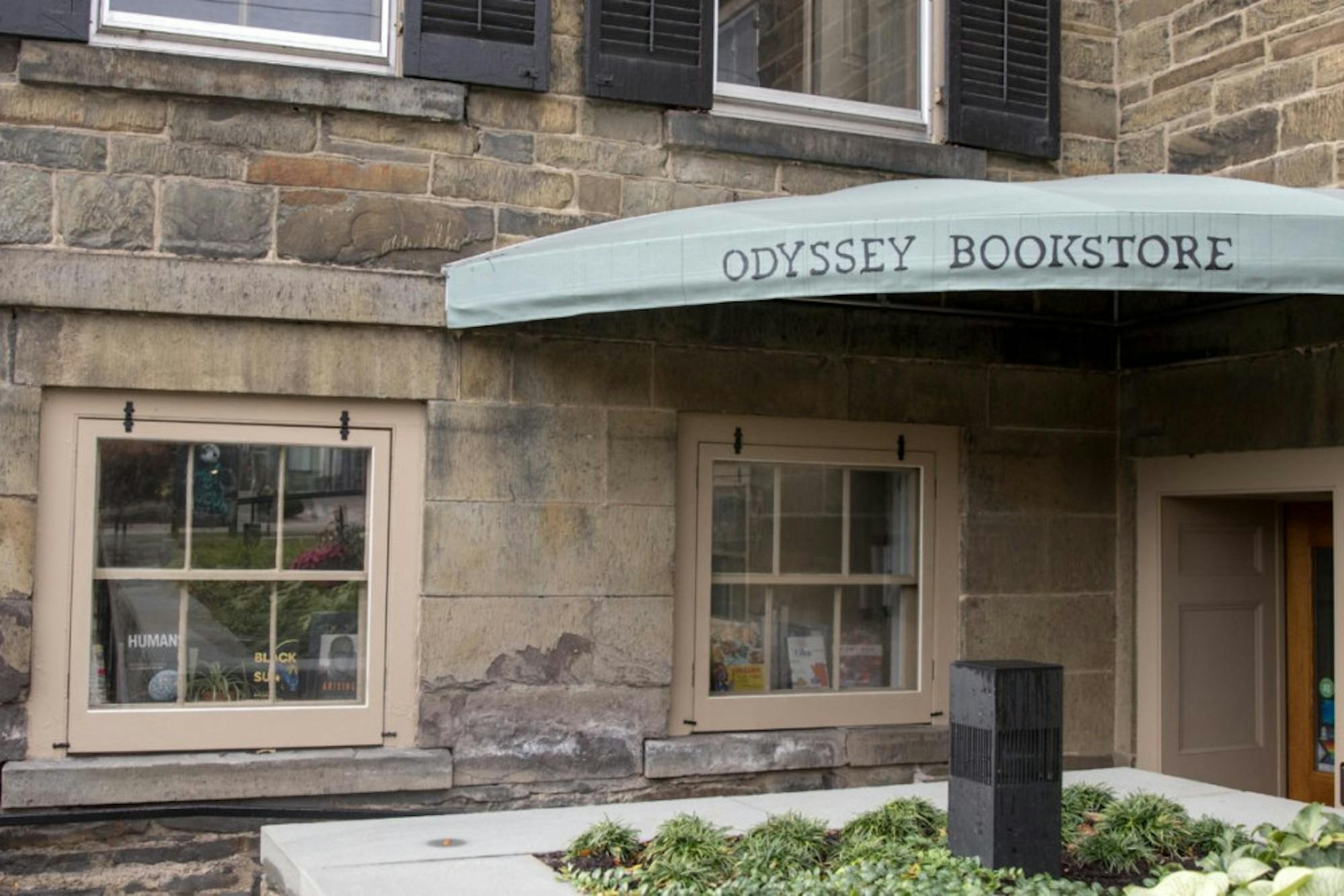 Books reflect through the Odyssey Bookstore windows.
