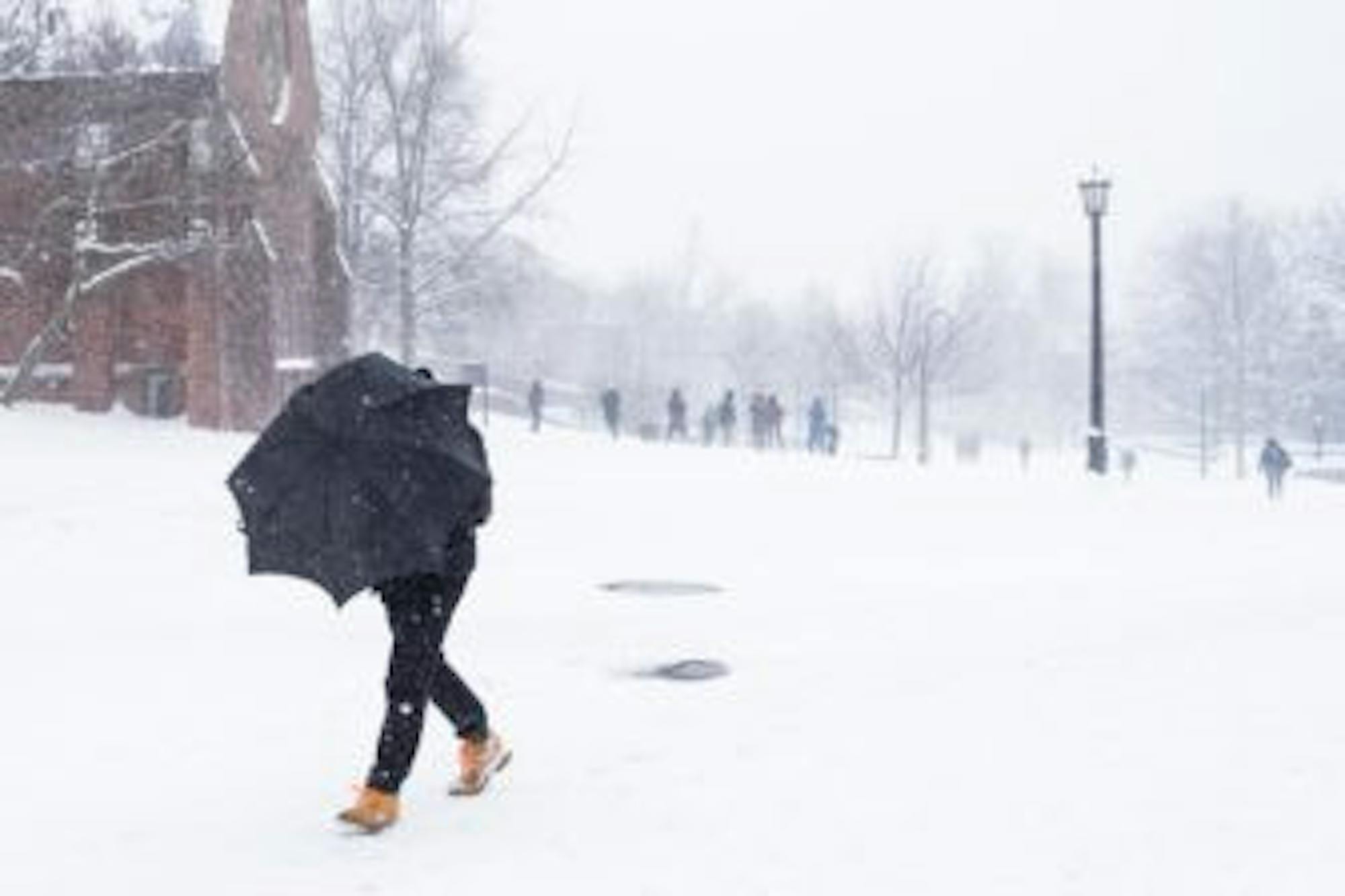 Student walks in front of Sage Chapel during Storm Stella on March 14, 2017. (Michael Suguitan/ Sun Staff Photographer)
