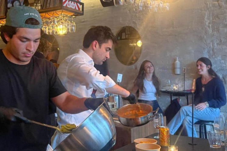 Mander works on a dish.