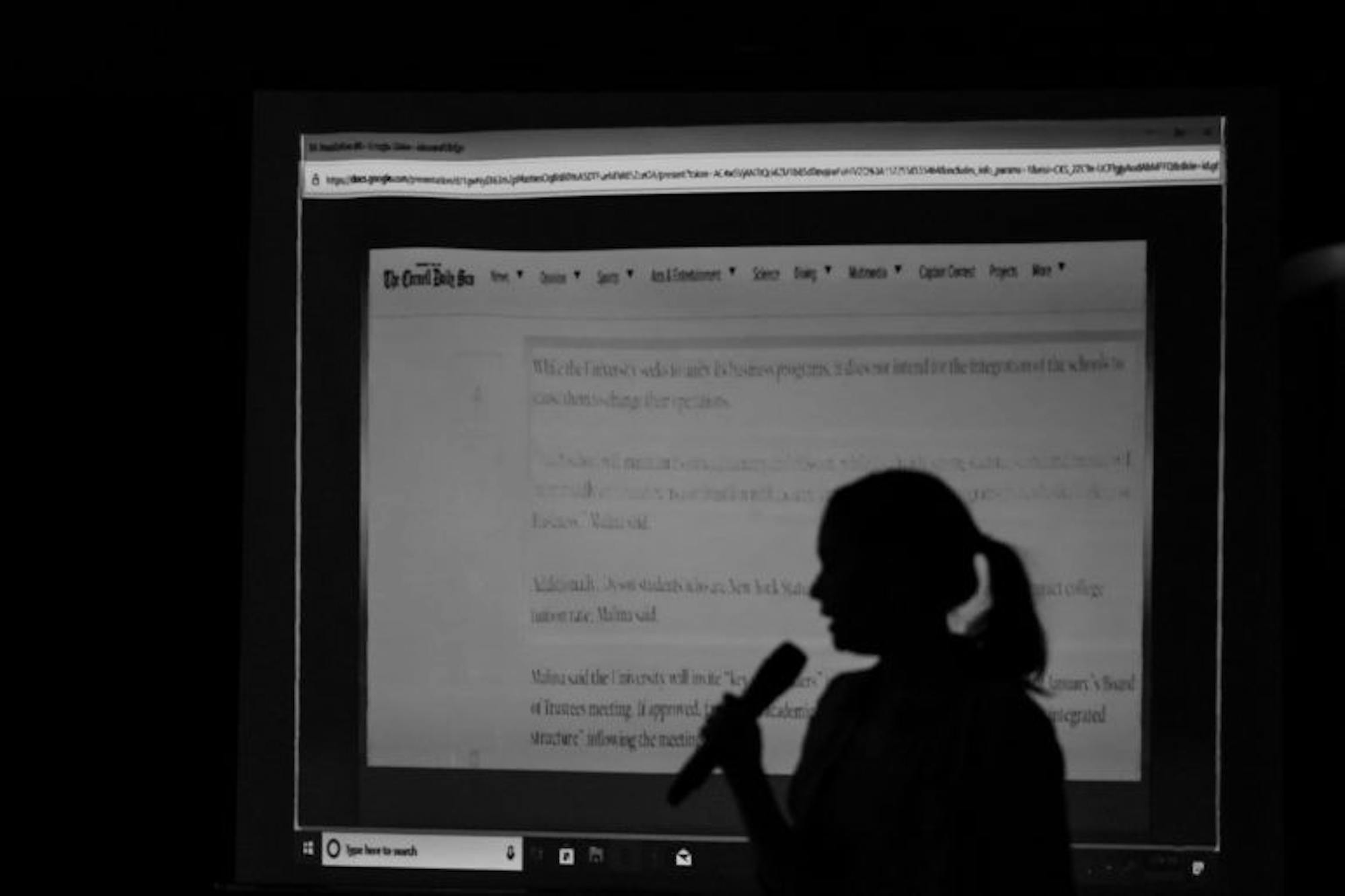 Solovyeva stands in front of the projector at the Oct. 31 meeting.