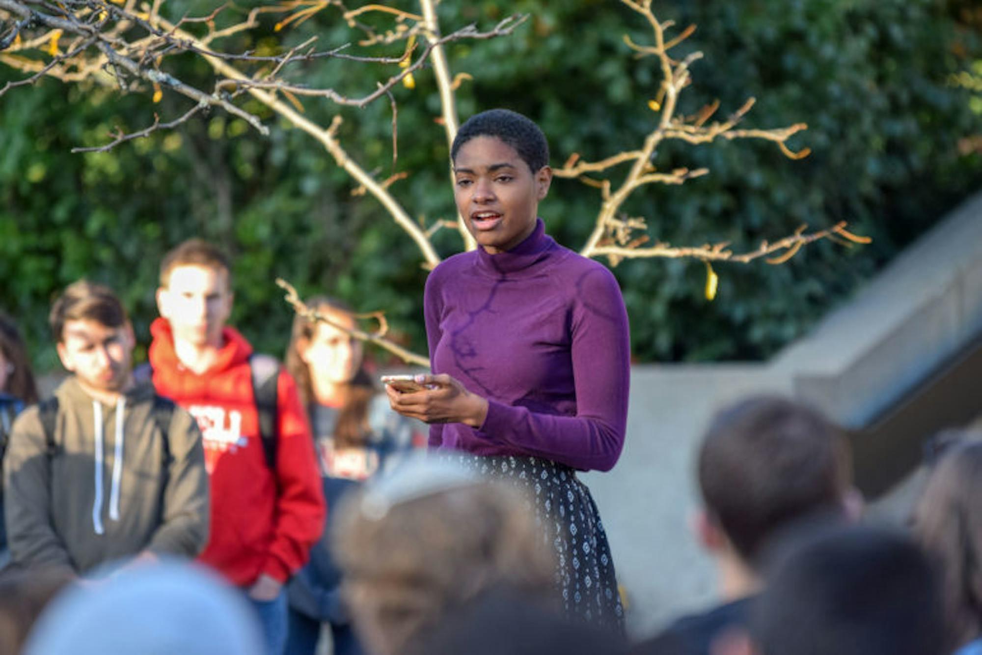 The crowd listens to speakers at the
