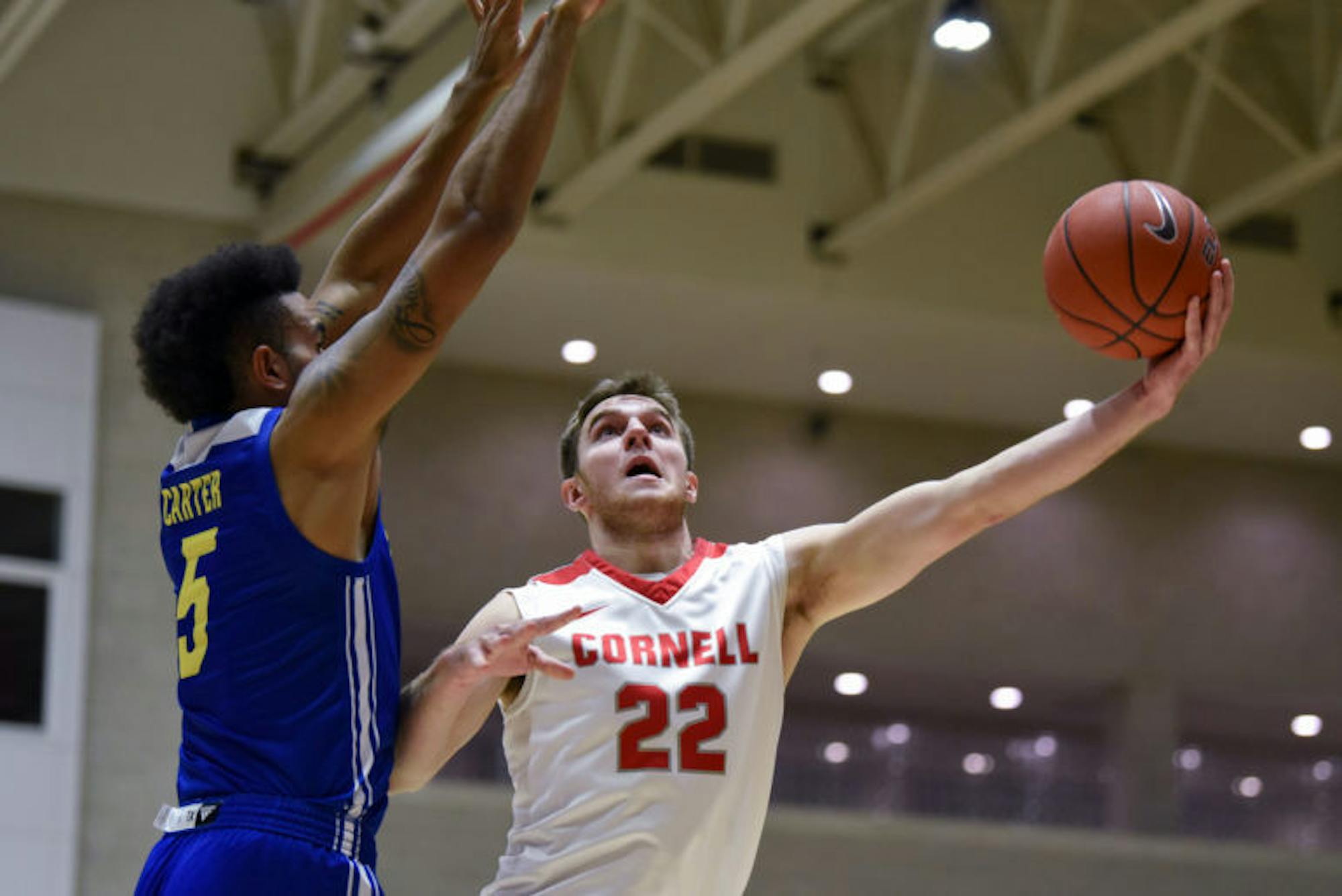 Junior forward Josh Warren puts up a layup at the men's basketball game against Delaware on Thursday. After a 9-2 run by the Blue Hens at the end of the first half, the Red struggled throughout the second half, ultimately falling 73-56. (Boris Tsang / Sun Assistant Photography Editor)