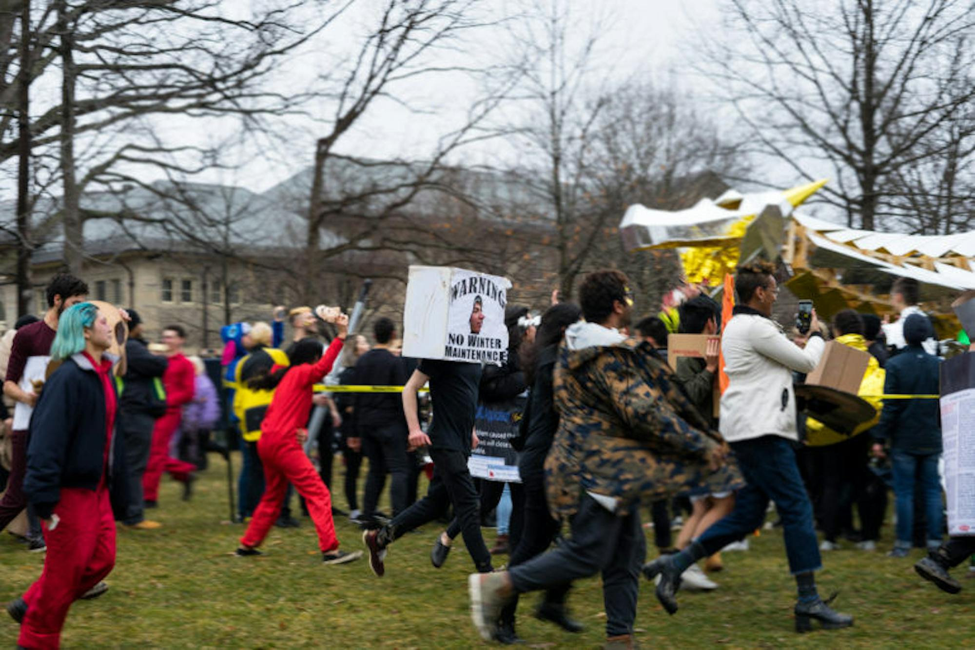 Paraders run around the dragon after it reaches its final destination on the Arts Quad.
