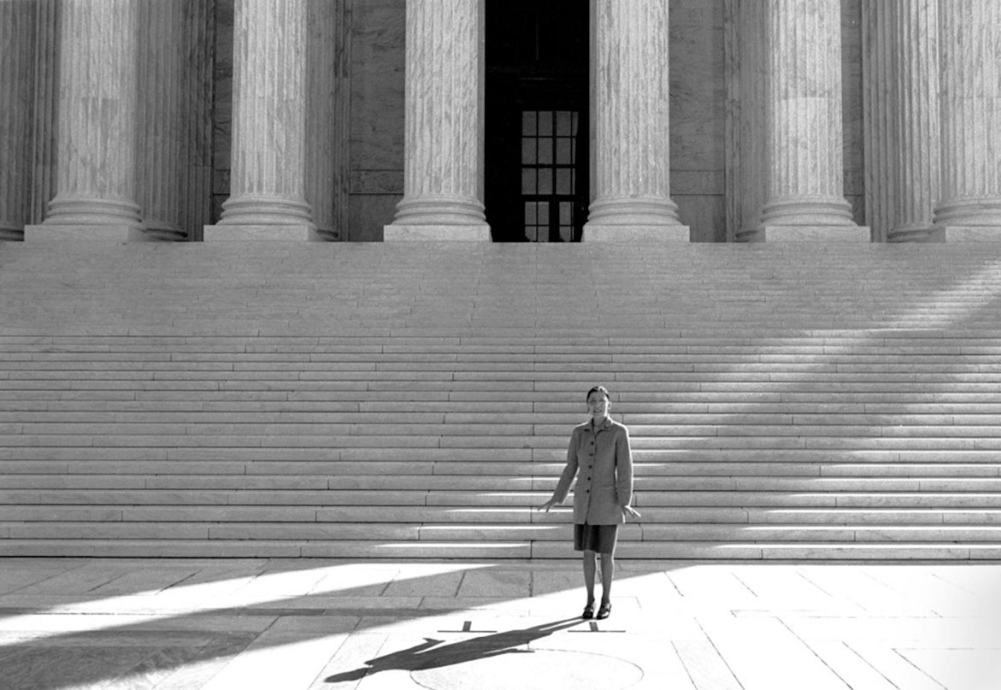 Justice Ruth Bader Ginsburg '54 stands outside the Supreme Court building in Washington on her first day on the job, Oct. 1, 1993. Ginsburg was the second woman to serve on the Supreme Court and a pioneering advocate for women’s rights.