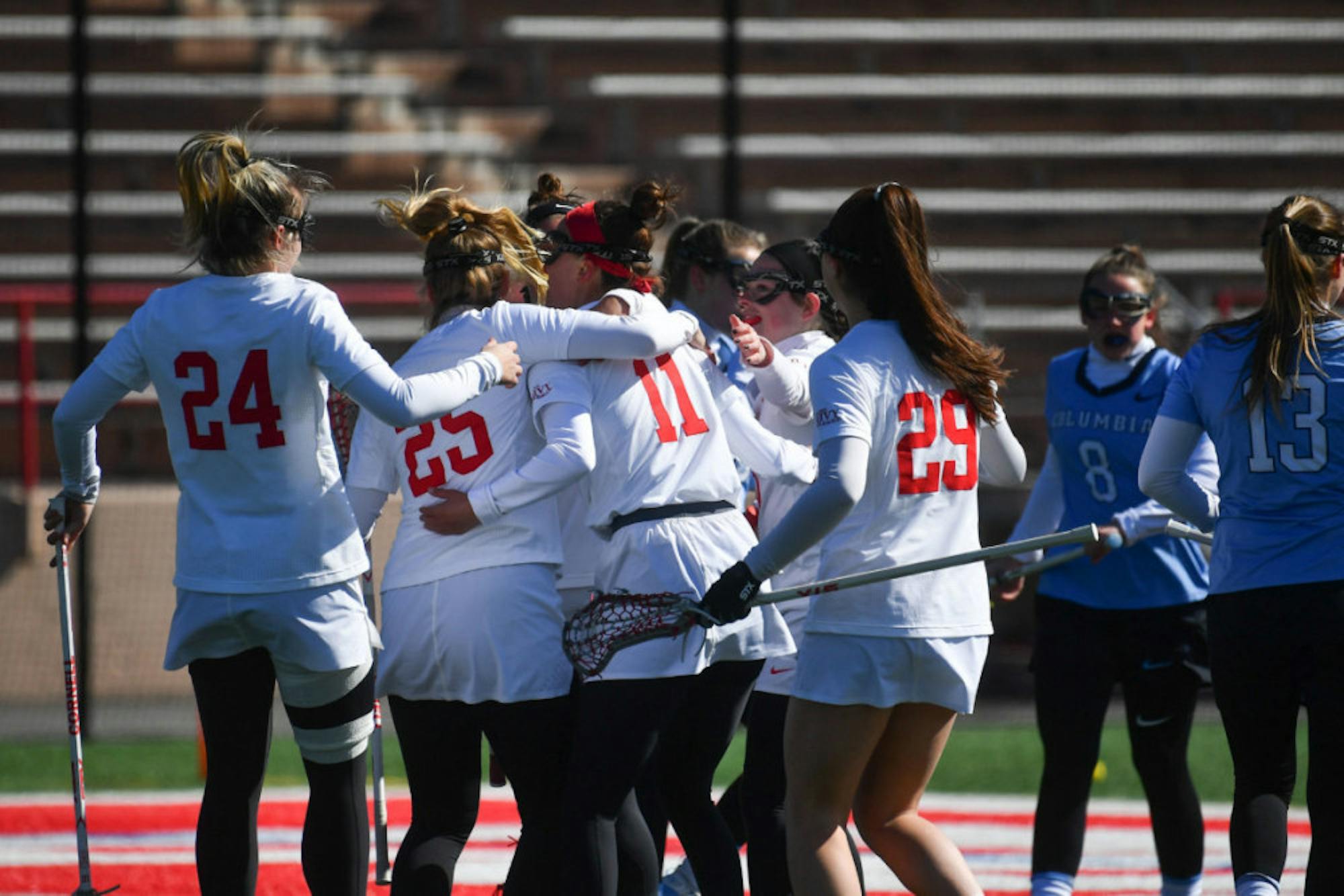 The women's lacrosse team celebrates their win against Columbia on Saturday. (Ben Parker/Sun Assistant Photography Editor)