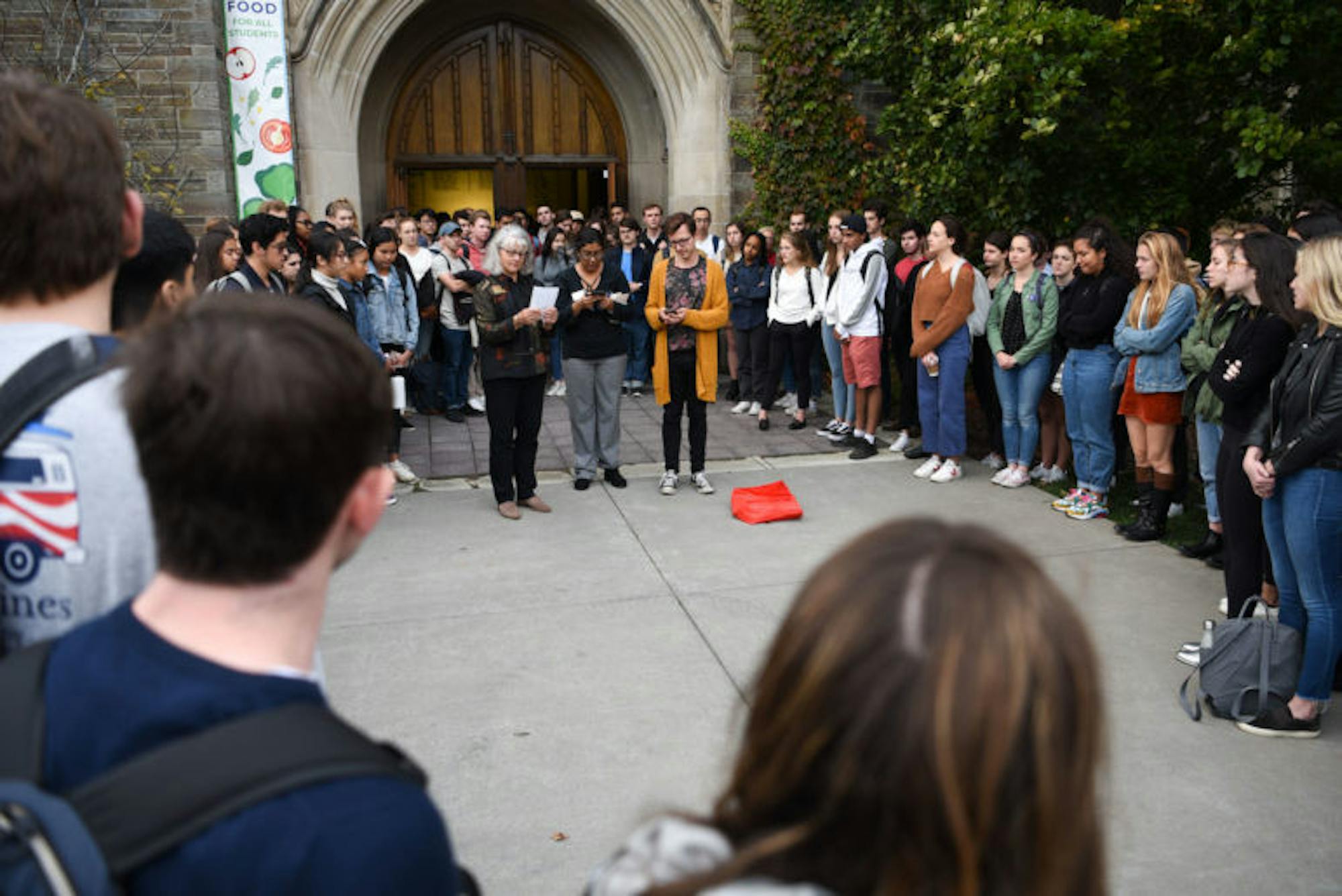 Staff members read some final words of remembrance to the participants outside the chapel during the service of remembrance for Antonio Tsialas '23 on October 29, 2019.