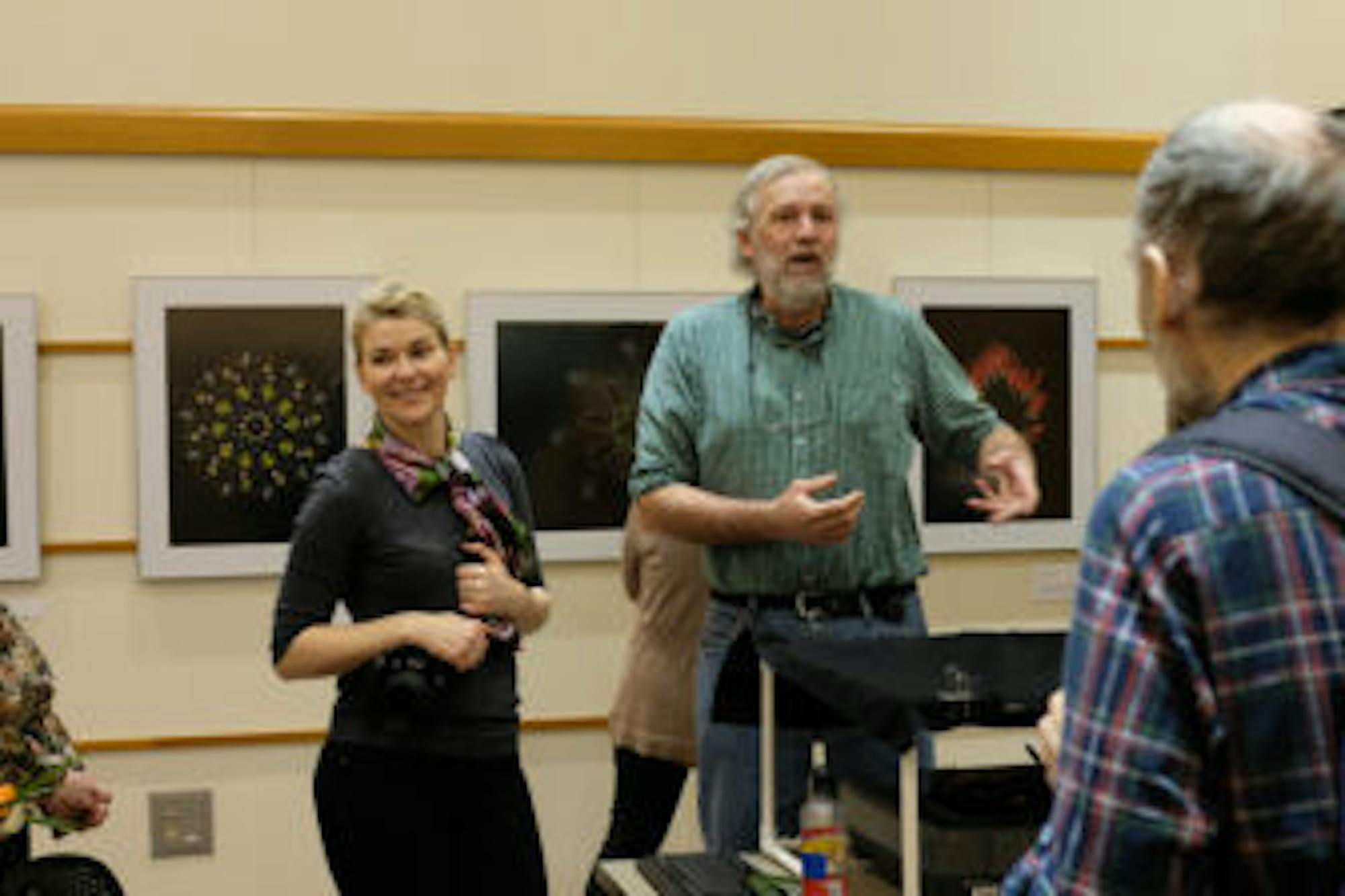 Craig Cramer, plant science, center, created many of the vibrant works on display in the exhibit.