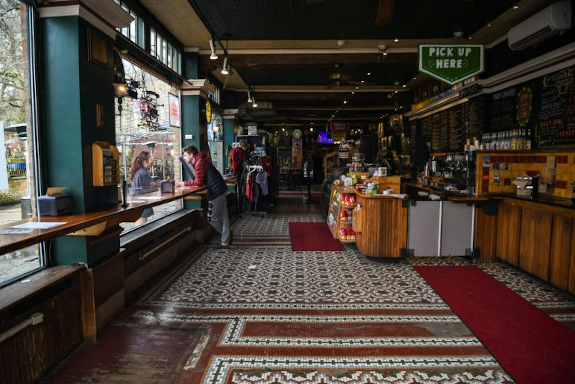 Collegetown Bagels in the College Avenue location lacked customers and furniture on Friday. After New York suspended restaurant dine-in operations on March 16, Ithaca food establishments removed their tables and chairs to prevent customers from staying for a meal. (Boris Tsang/Sun Photography Editor)