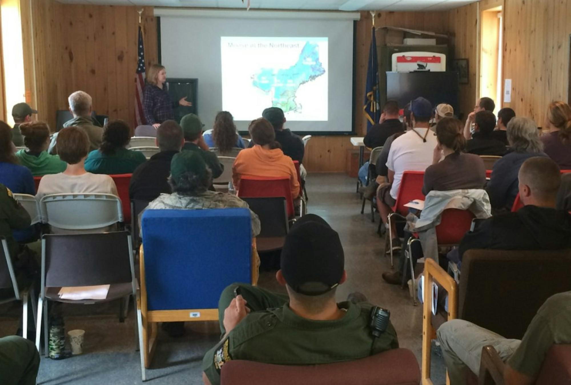 Krysten Schuler discusses the results of a moose health survey project with DEC staff.