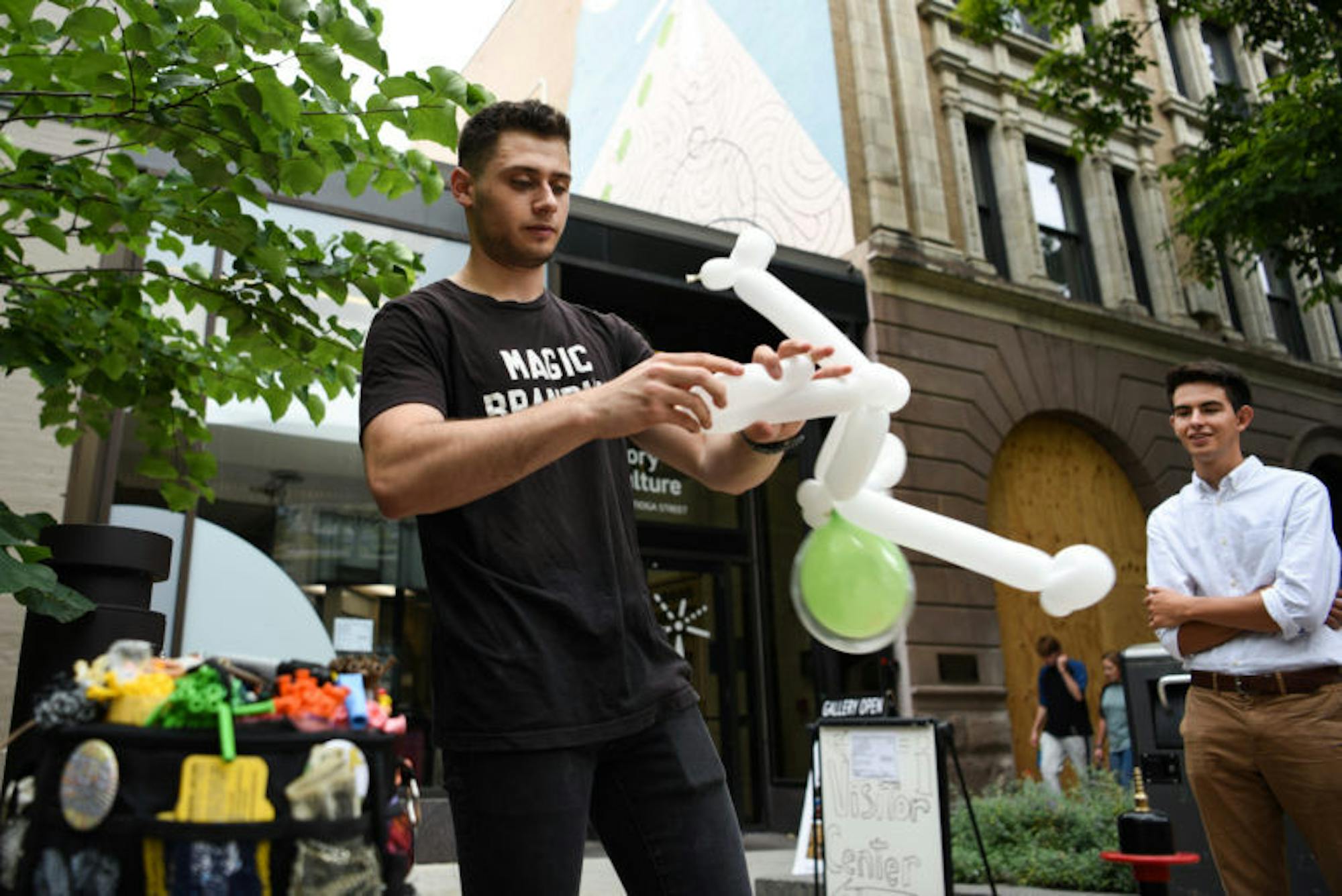 Brandon Axelrod fashions an alien astronaut out of balloons during C.U. Downtown at the Ithaca Commons on September 7th, 2019.