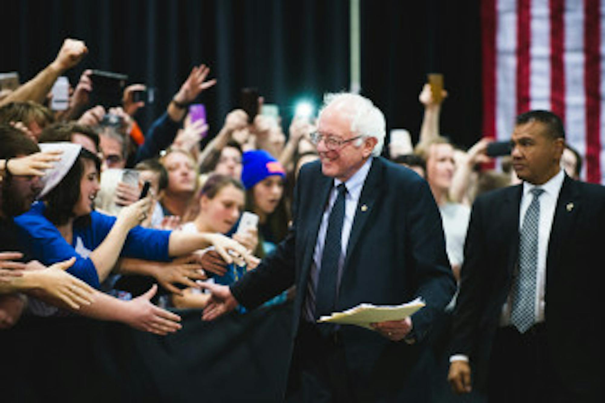 Bernie Sanders greets supporters as he walks to the podium at the Oncenter in Syracuse.