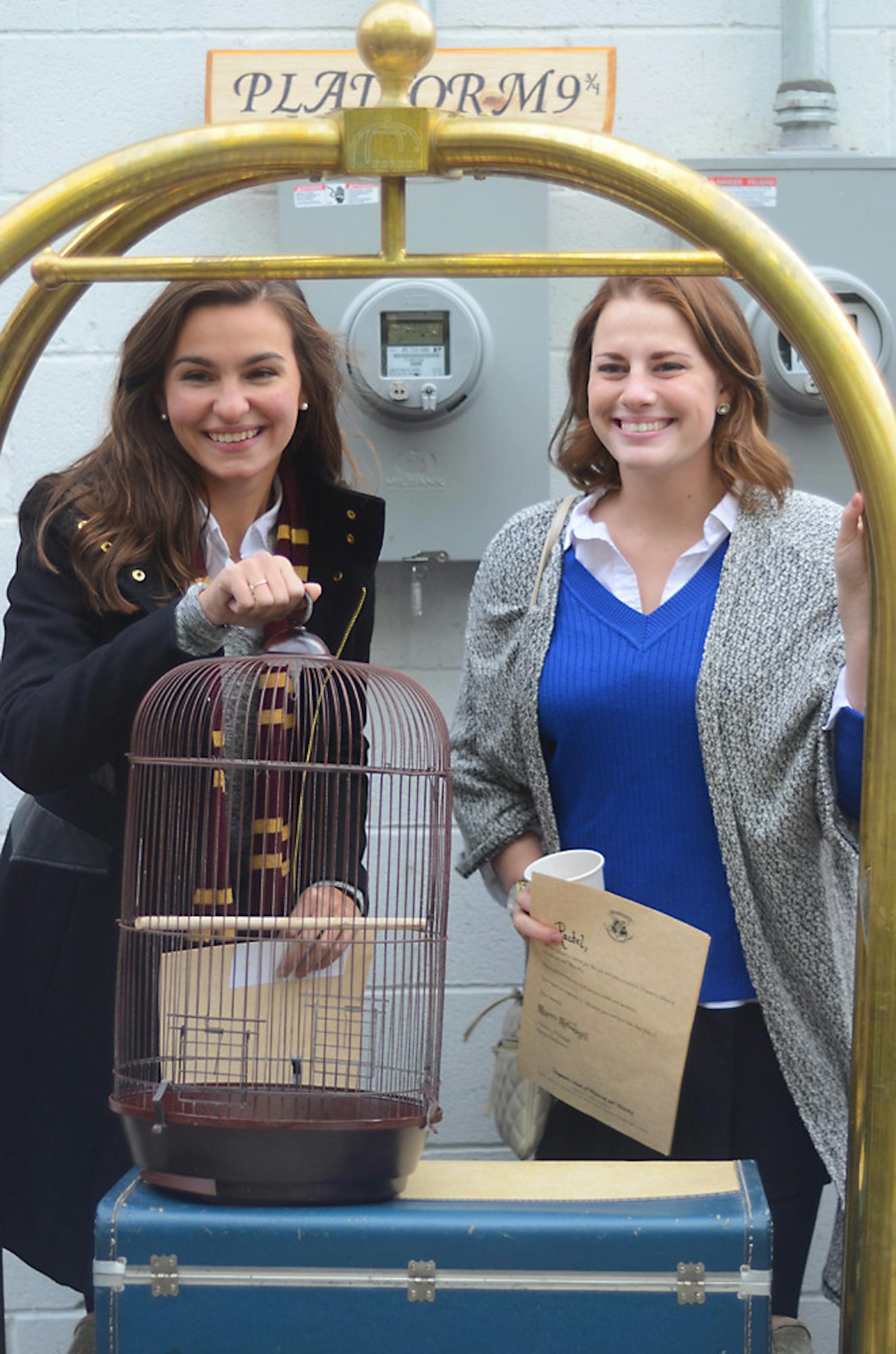 (JADE SONG / SUN STAFF PHOTOGRAPHER) Members of the Ithaca community dress up in their wizarding clothes and wait outside platform 9 3/4.