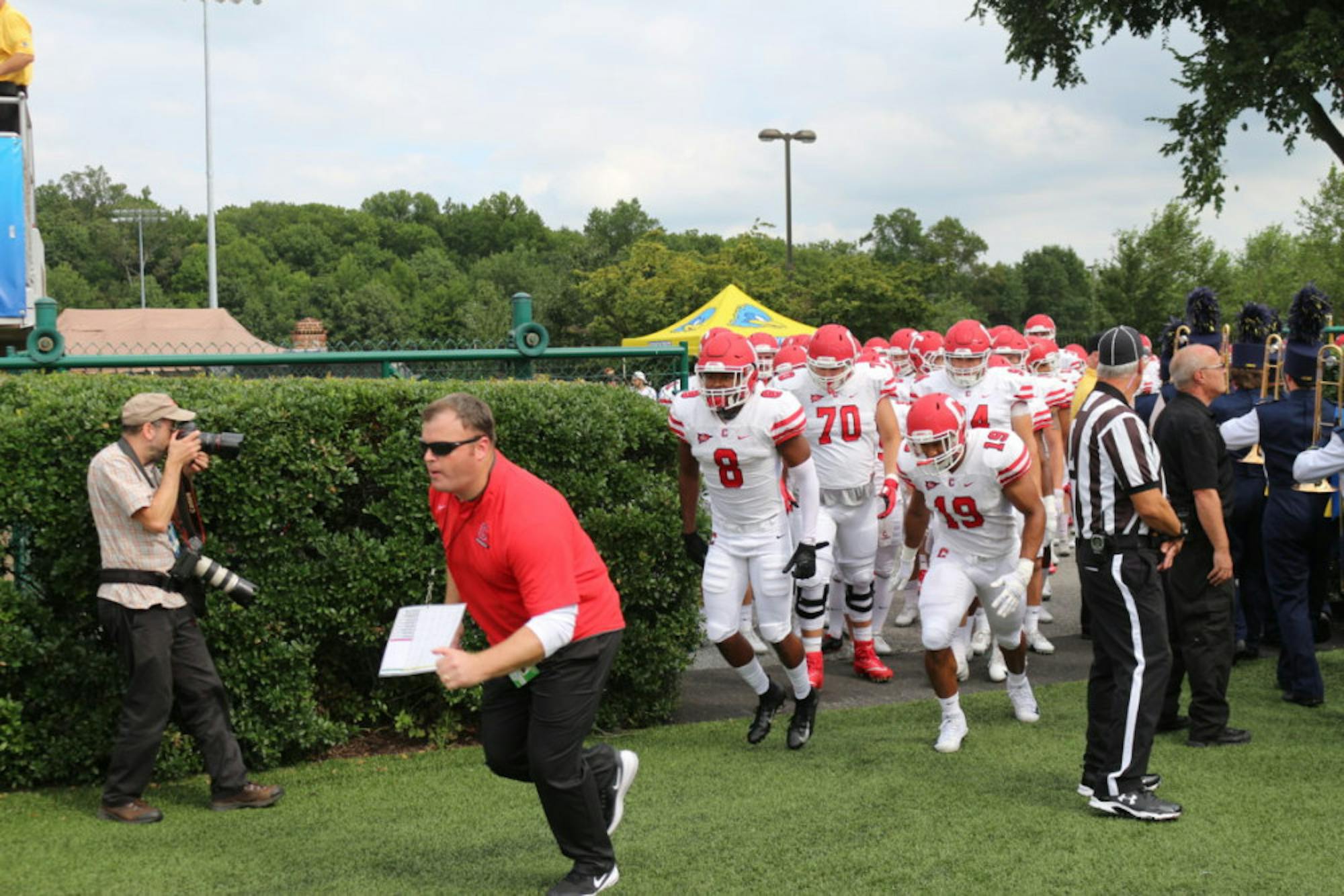 Head coach David Archer '05 leads his team onto the field for the second consecutive year in Delaware.