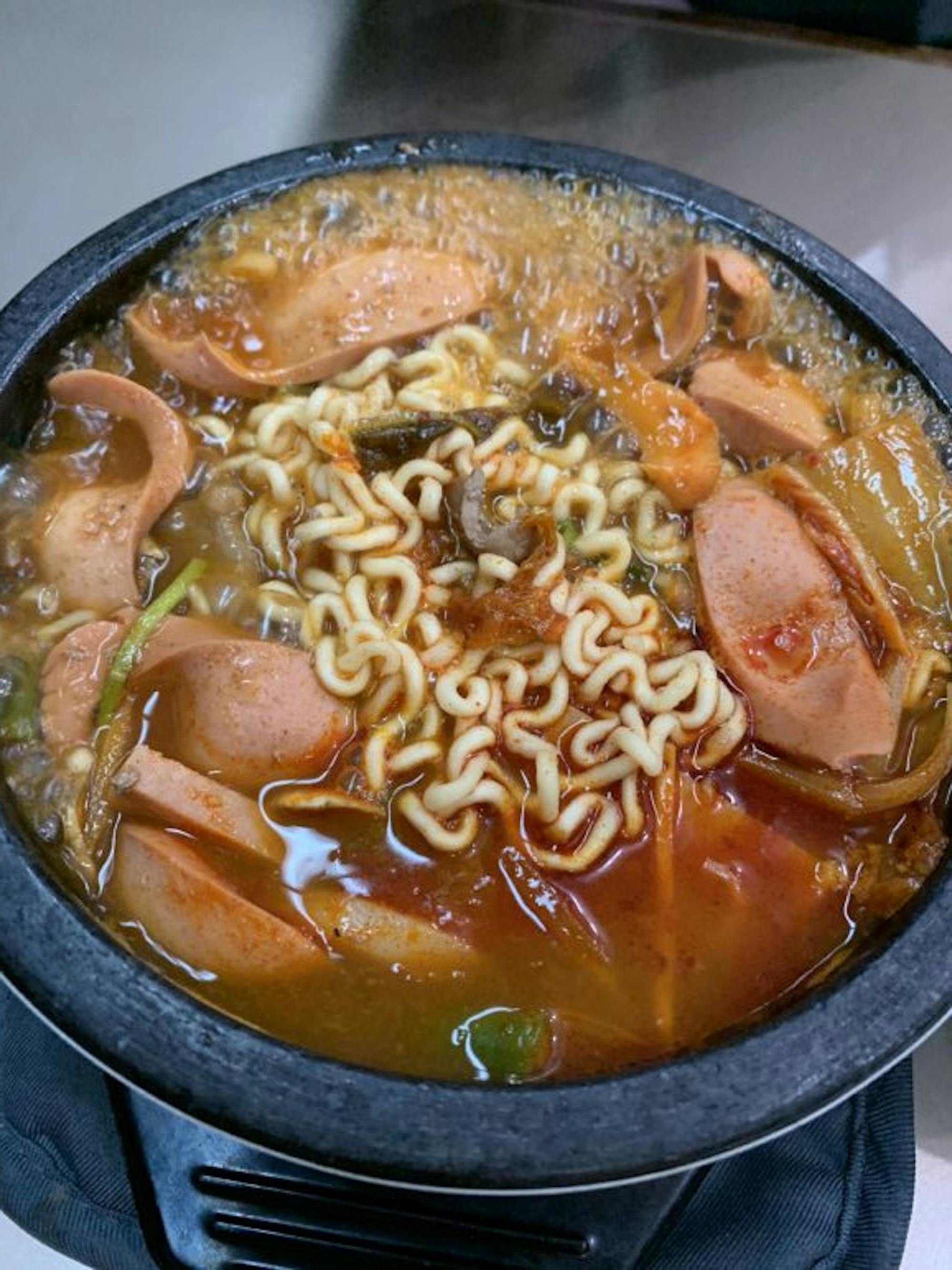 Budae jjigae, a sausage stew that comes with a variety of toppings such as ramen, rice cakes and kimch. (Grace Kim/Sun Contributor)