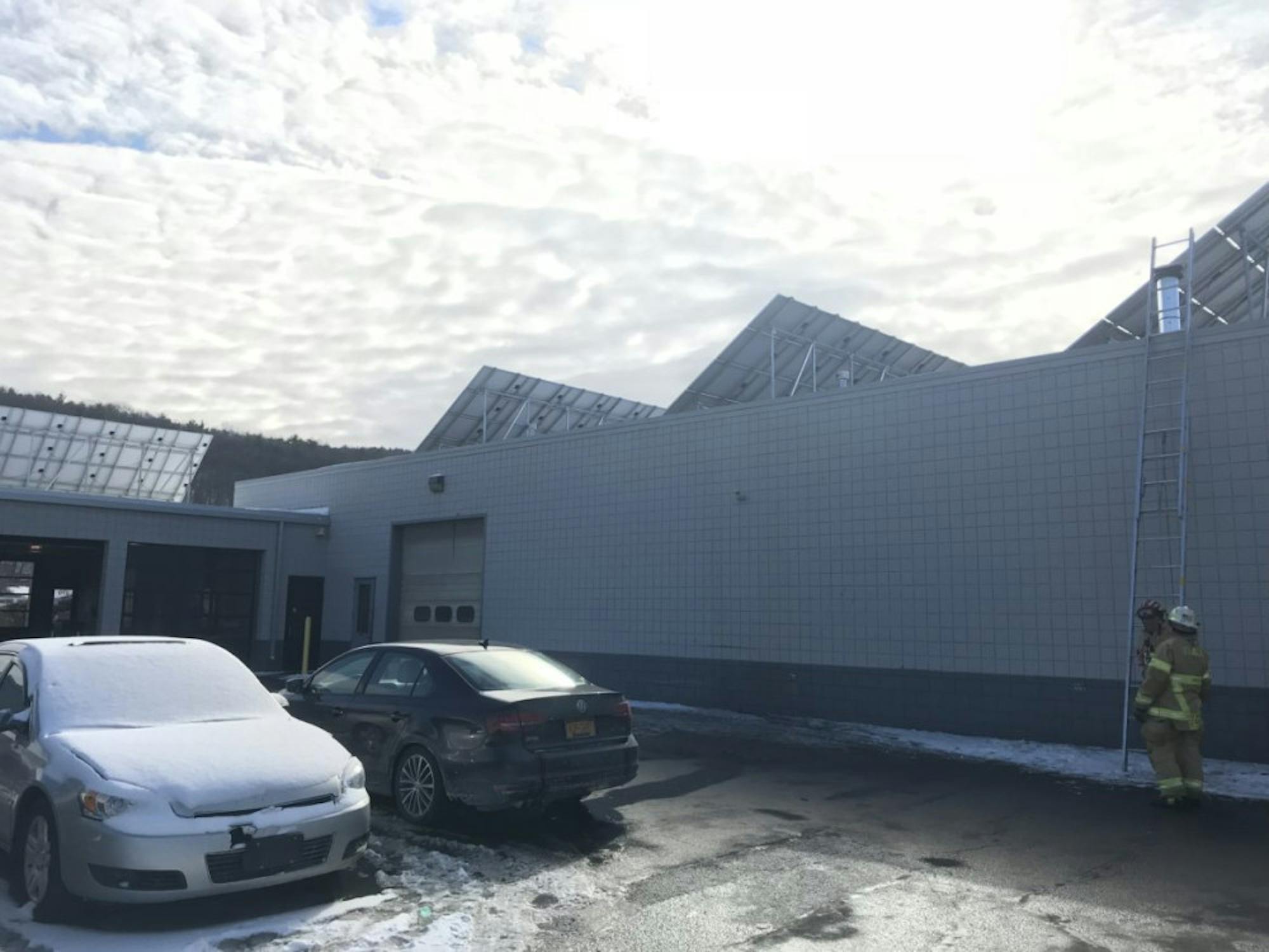 Members of the Ithaca Fire Department behind the Maguire Family of Dealerships headquarters at about 1 p.m. on Saturday.
