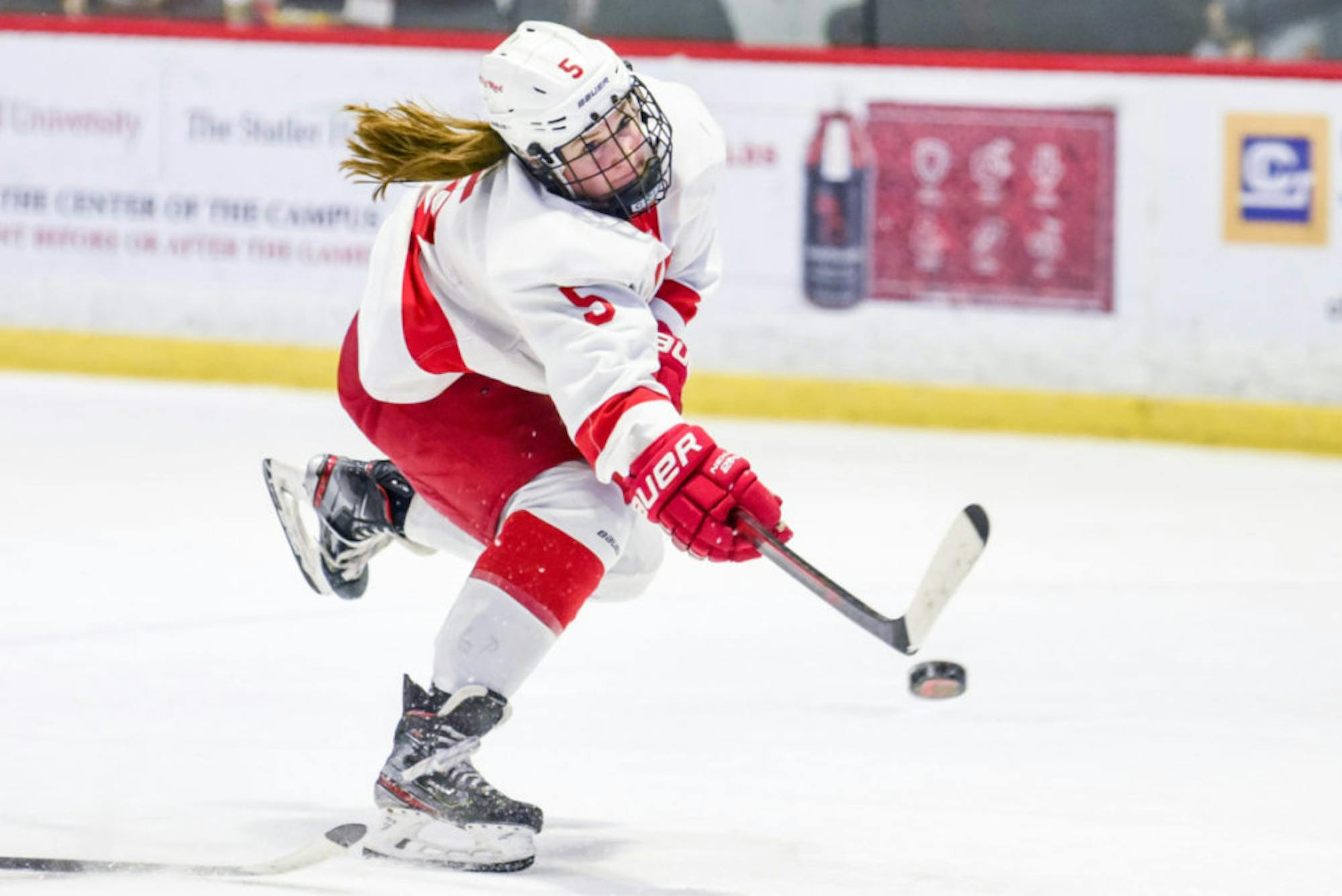Senior forward Grace Graham shoots and scores to put the Red up 3-1 in the third period at the women's hockey game against St. Lawrence on Saturday. With this feat, women's hockey secured the win to participate in the ECAC Semifinal next weekend. (Boris Tsang/Sun Photography Editor)