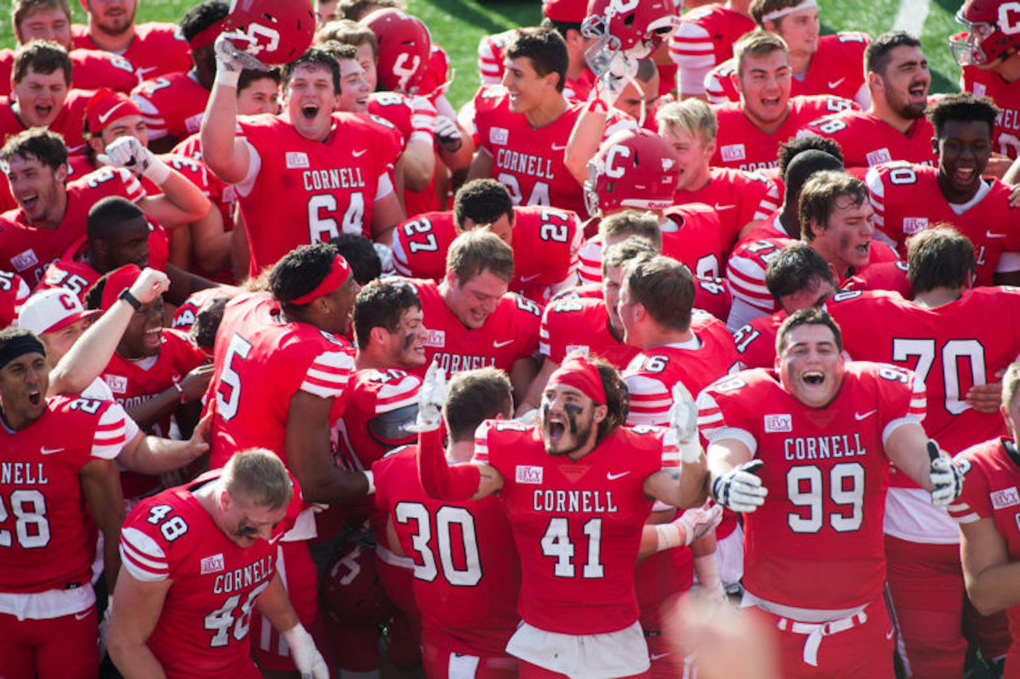 Members of the 130th Cornell football team belt out a rendition of “Cornell Victorious” for the first time of the year. (Cameron Pollack/Sun Photography Editor)