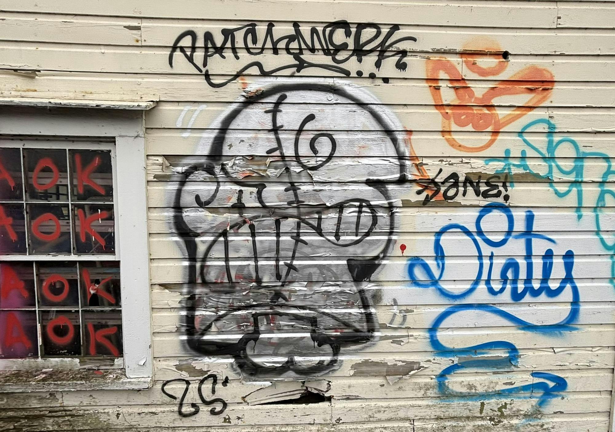 Photo of white and black tag on rundown wall.jpeg