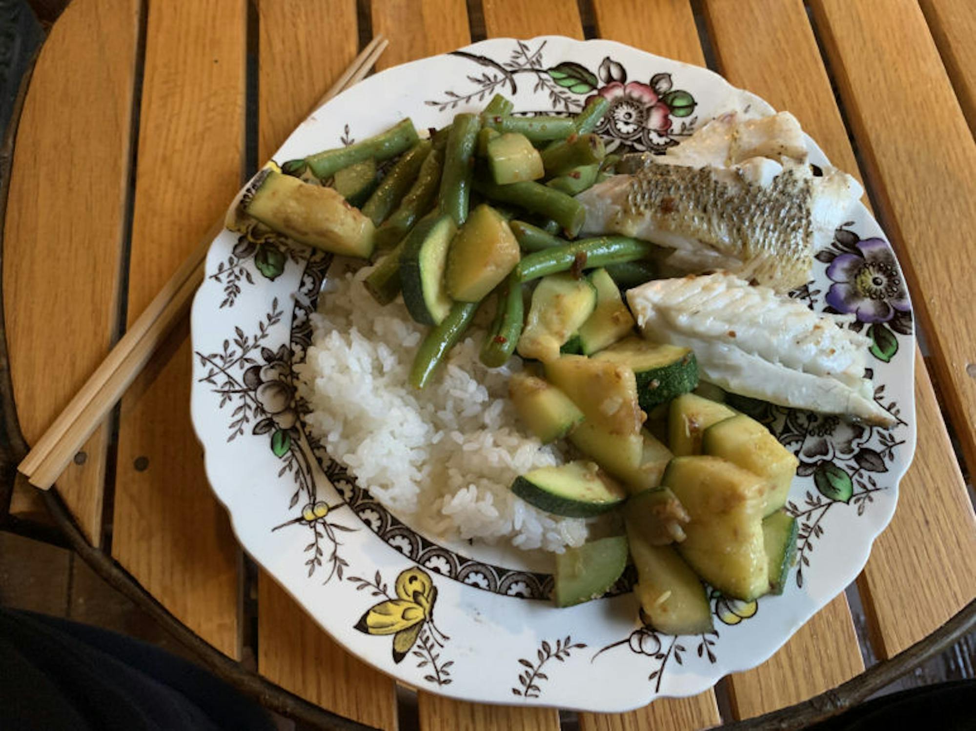 Steamed largemouth bass with sautéed zucchini and beans over rice. (Benjamin Velani / Sun Dining Editor)