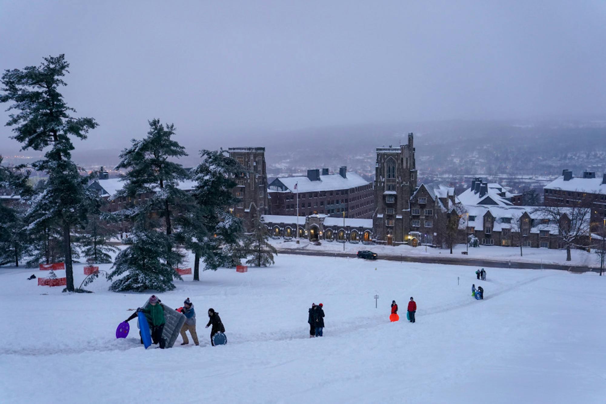 Converting Libe Slope into a ski and sledding hill, students used dorm items, skis and snowboards, and packaging materials to slide down the Slope and celebrate the snow day on Friday. This was the first snow day of the semester and the second snow day of the year. (Ben Parker/Sun Assistant Photography Editor)