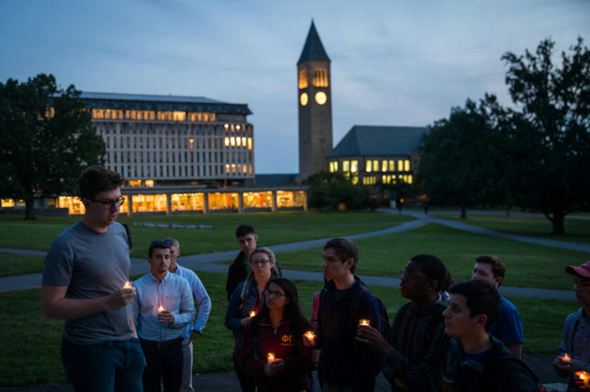 Austin McLaughlin '18, President of the Cornell Republicans (left), speaks at a candlelight vigil hosted by the Cornell Republicans on the Arts Quad on September 11th, 2017. (Cameron Pollack / Sun Photography Editor)