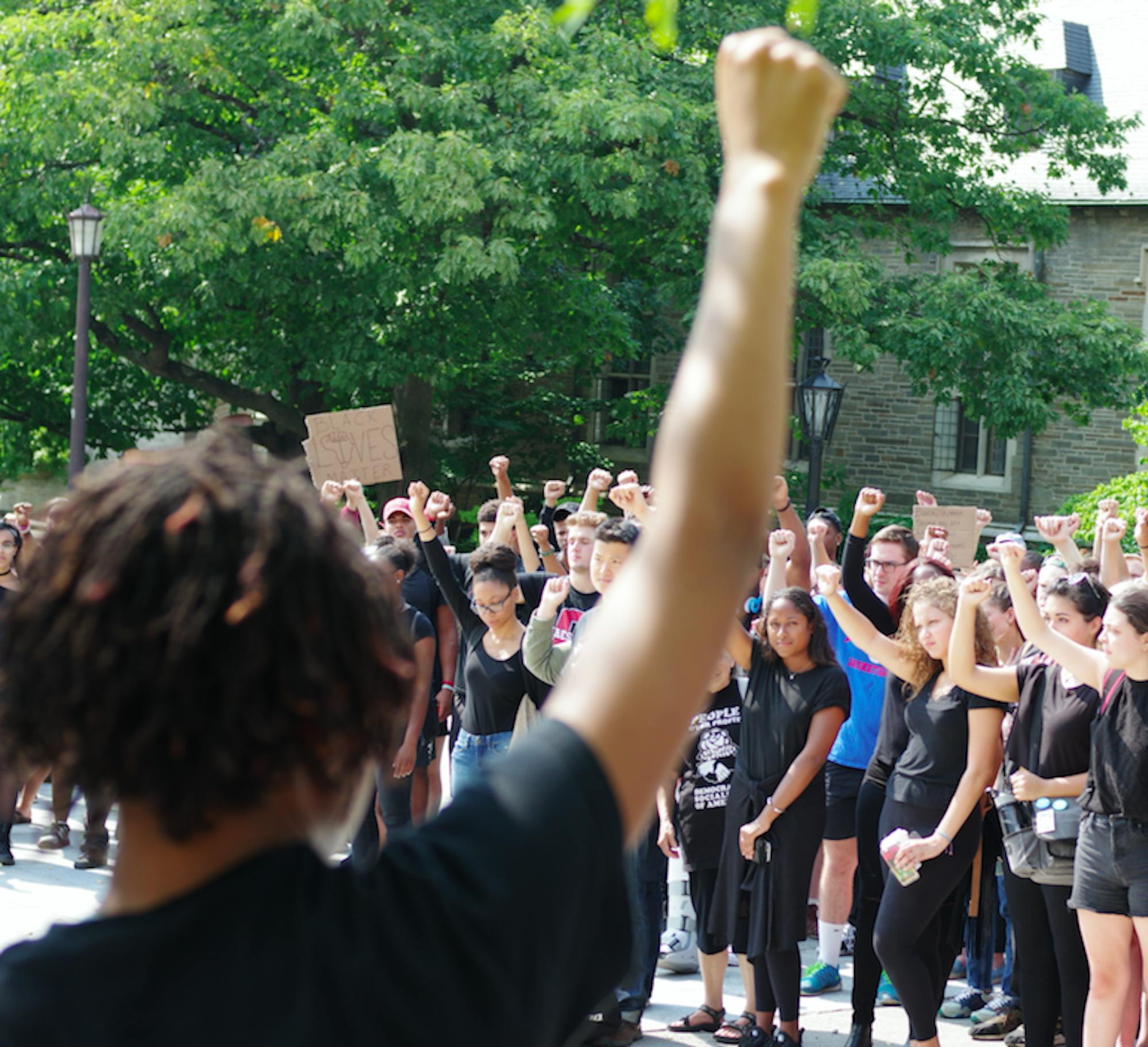 Protestors raise their fists at a Black Students United Rally on Friday.
