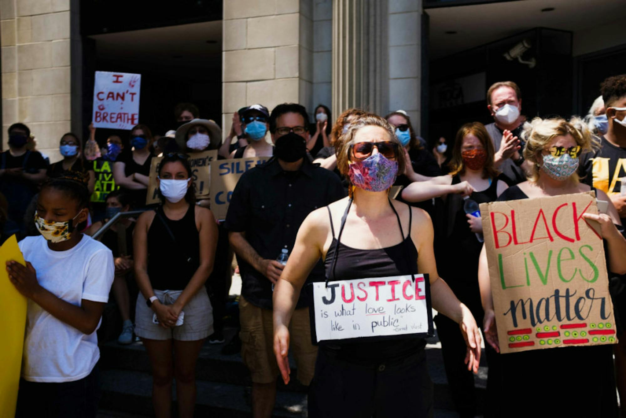 Black Lives Matter rallies participants to hold hand-painted signs, with many wearing black and sporting masks. (Michael Suguitan / Sun Staff Photographer).